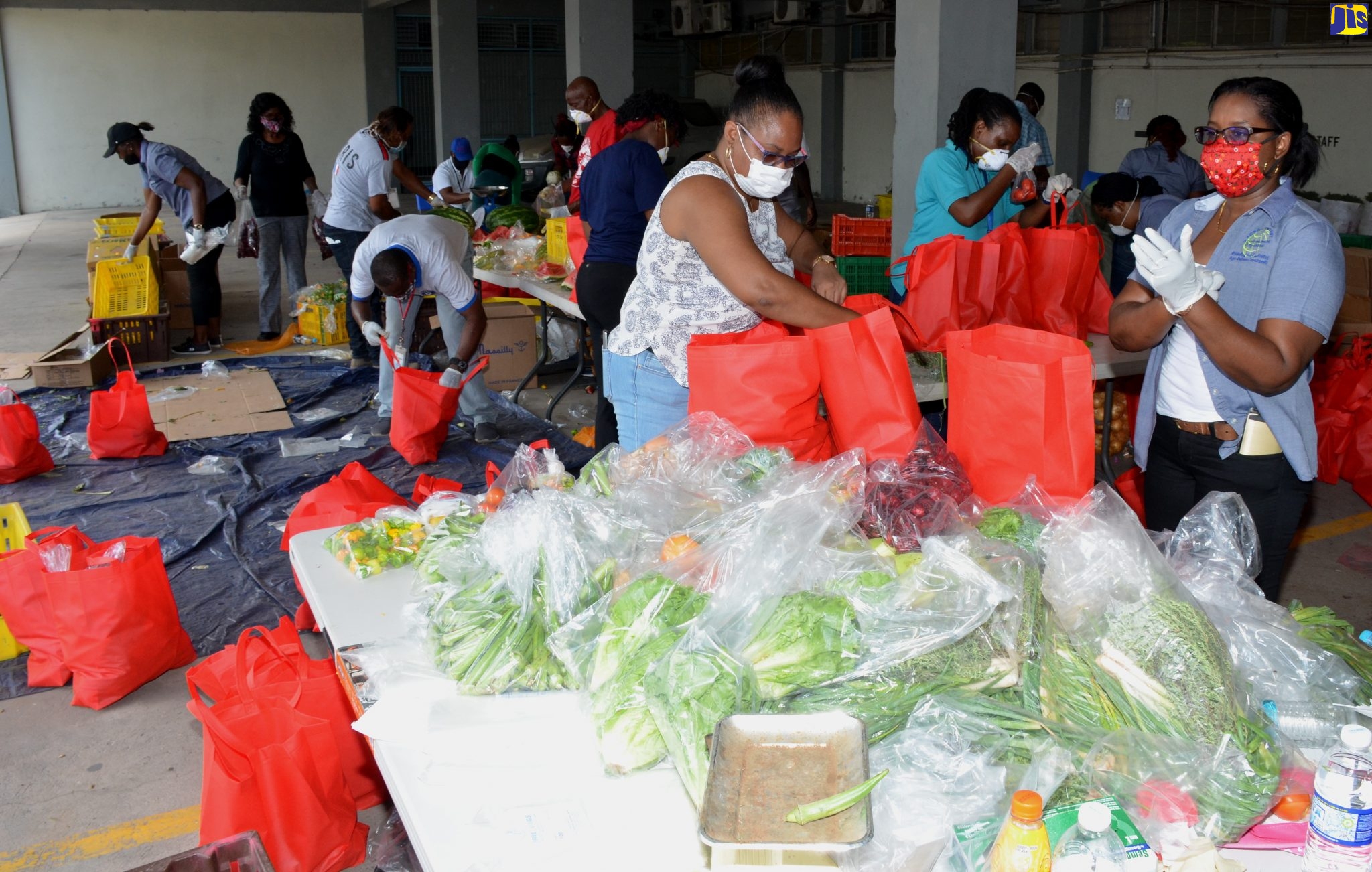 Workers packaging food items at the first Drive-Thru Farmers’ Market, organised by the Agro-Investment Corporation on Wednesday (April 29), at 188 Spanish Town Road, Kingston 11.