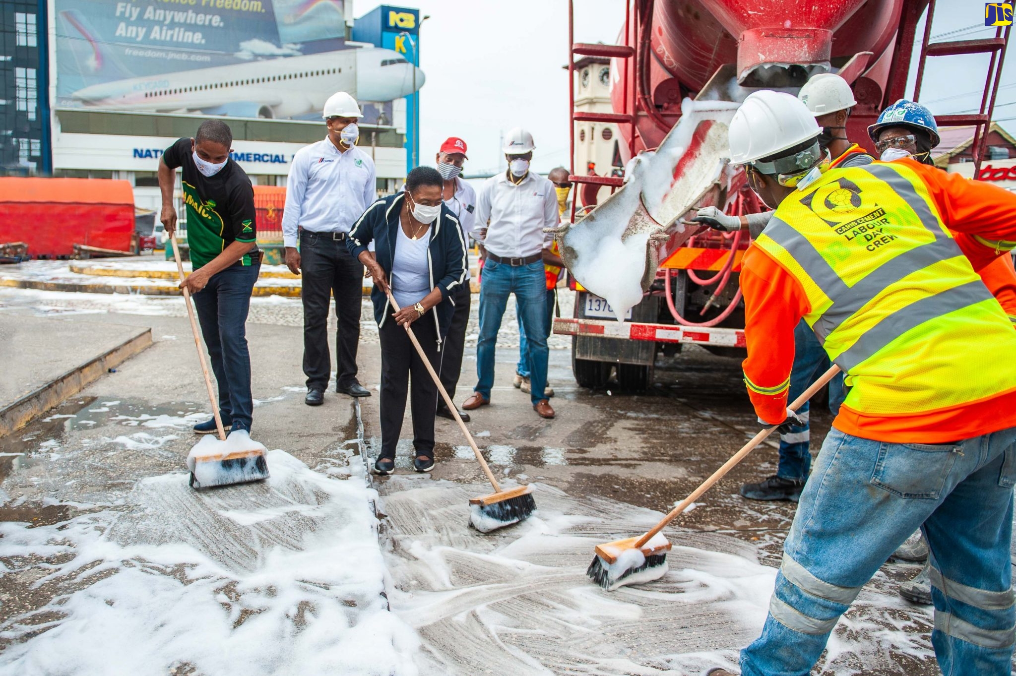 The Minister of Culture, Gender, Entertainment and Sport, the Honourable Olivia Grange (3rd left) and the Mayor of Kingston, Senator Councillor Delroy Williams (left), join the work crew from Carib Cement Company and Jamaica Pre-Mix in a Labour Day sanitisation project at Mandela Park in Half Way Tree. Also pictured are: Sales Manager at Carib Cement Garen Williams; Managing Director of Jamaica Pre-Mix Limited, John Valentine; and Industrial and Builders Manager at Carib Cement, Andre Nelson.