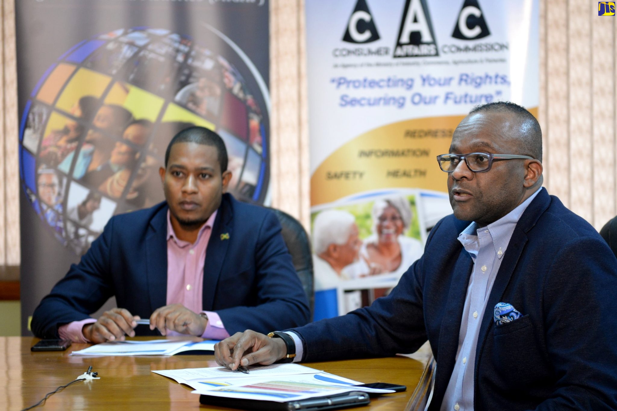Chairman of the CAC, Donovan White (right), speaks at a recent virtual press briefing to outline details of the Government