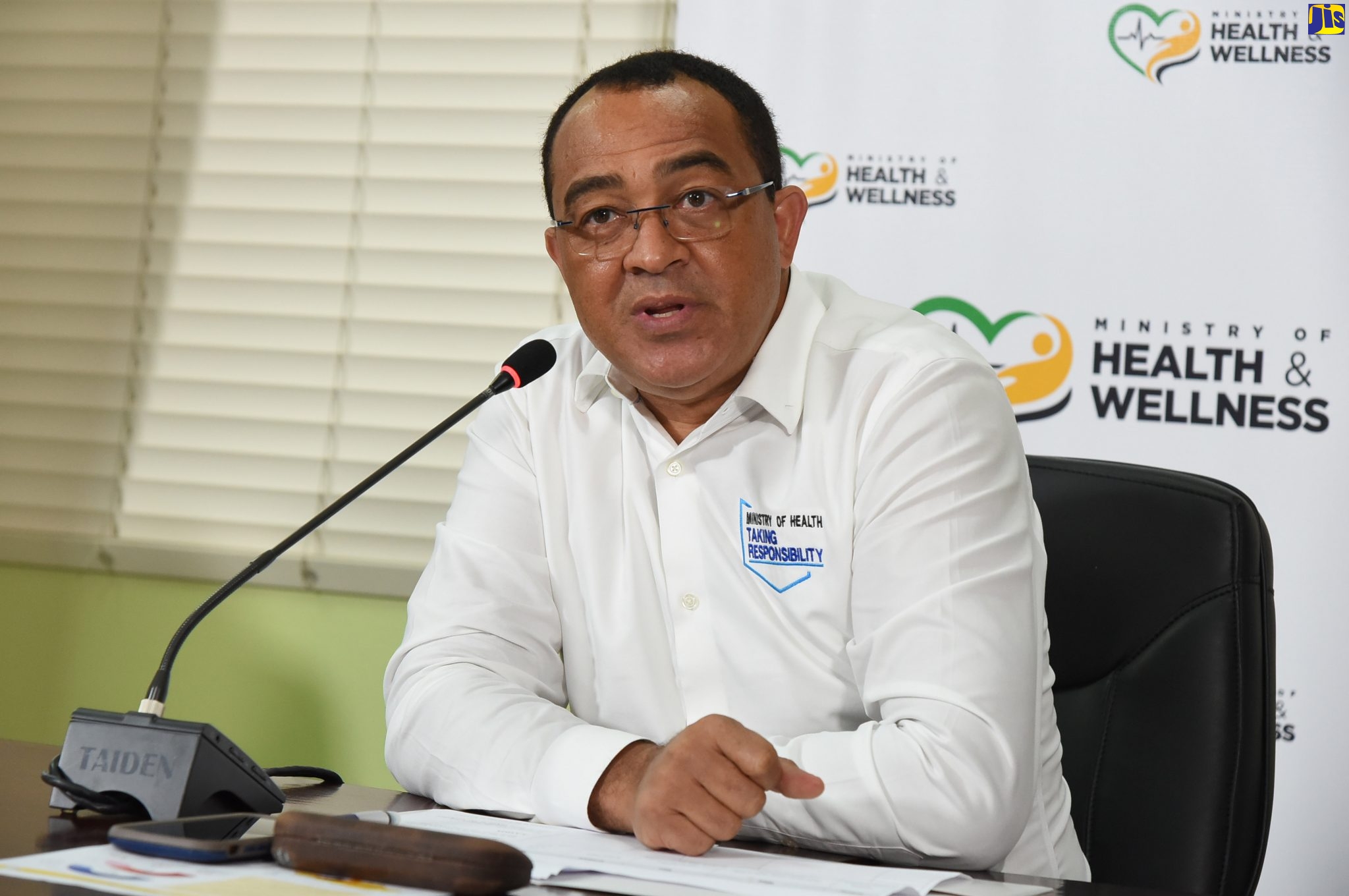Minister of Health and Wellness, Dr. the Hon. Christopher Tufton (left), addresses a digital press conference from the Ministry