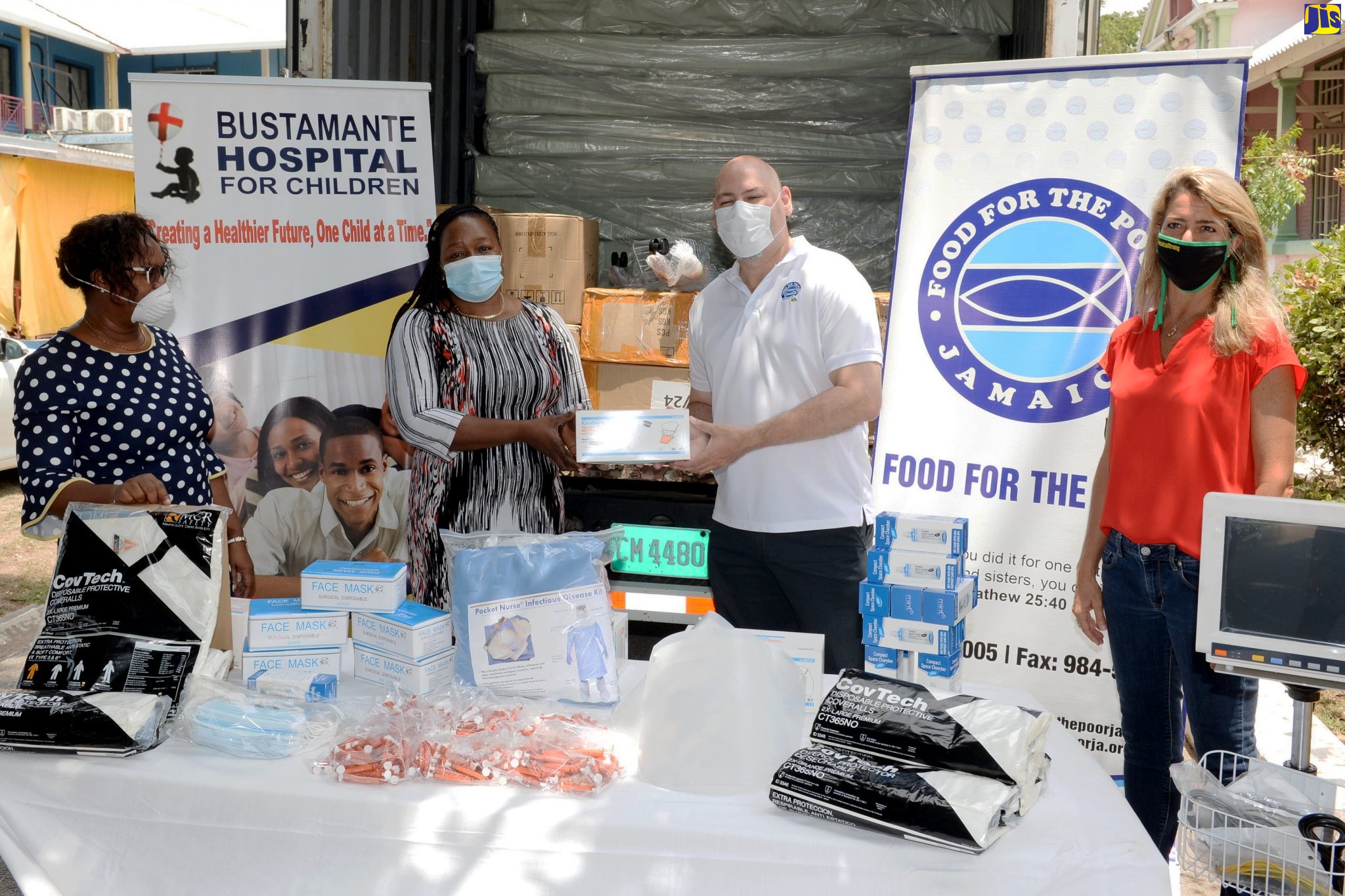 Regional Director, South East Regional Health Authority (SERHA), Maureen Golding (second left), accepts personal protective equipment (PPE) from Director, Food For the Poor, Craig Moss-Solomon, at a handover ceremony at the Bustamante Hospital for Children, Arthur Wint Drive in Kingston, on May 28. Sharing the moment (from left) are Chief Executive Officer, Bustamante Hospital for Children, Camile Wallen Panton; and Donor Representative, Tanya Khouri. Food For the Poor Jamaica; handed over the personal protective equipment to health facilities within SERHA.