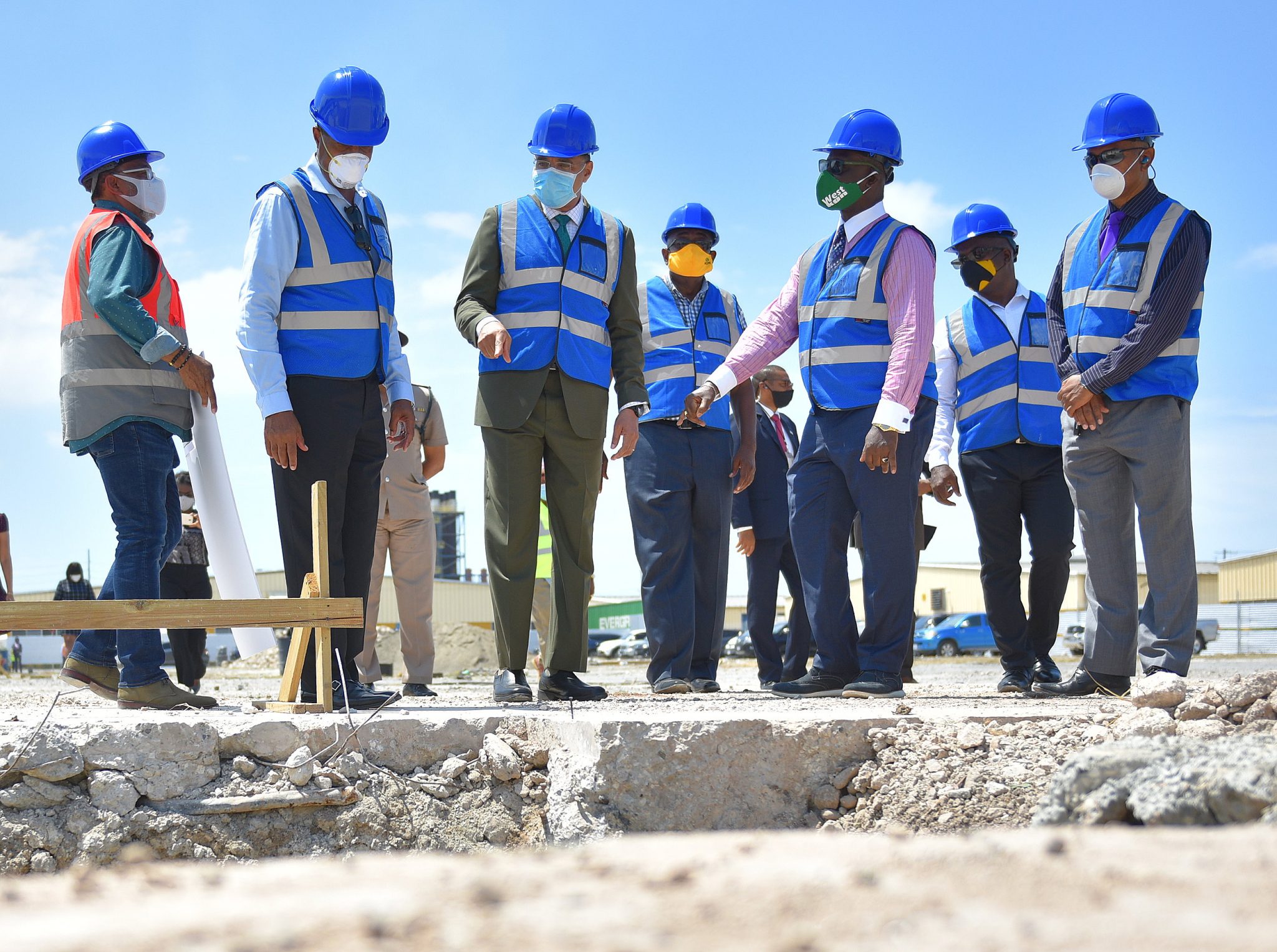 Prime Minister, the Most Hon. Andrew Holness (third left), views work being carried out under the Factories Corporation of Jamaica (FCJ) redevelopment and expansion project at the Garmex Free Zone Complex on Marcus Garvey Drive in Kingston, during a breaking of ground and tour of the project site on Wednesday (May 13). Among those accompanying him are: FCJ Chairman, Lyttleton Shirley(second right); and Local Government and Community Development Minister and Member of Parliament for West Kingston, where the complex is located, Hon. Desmond McKenzie (third right).
