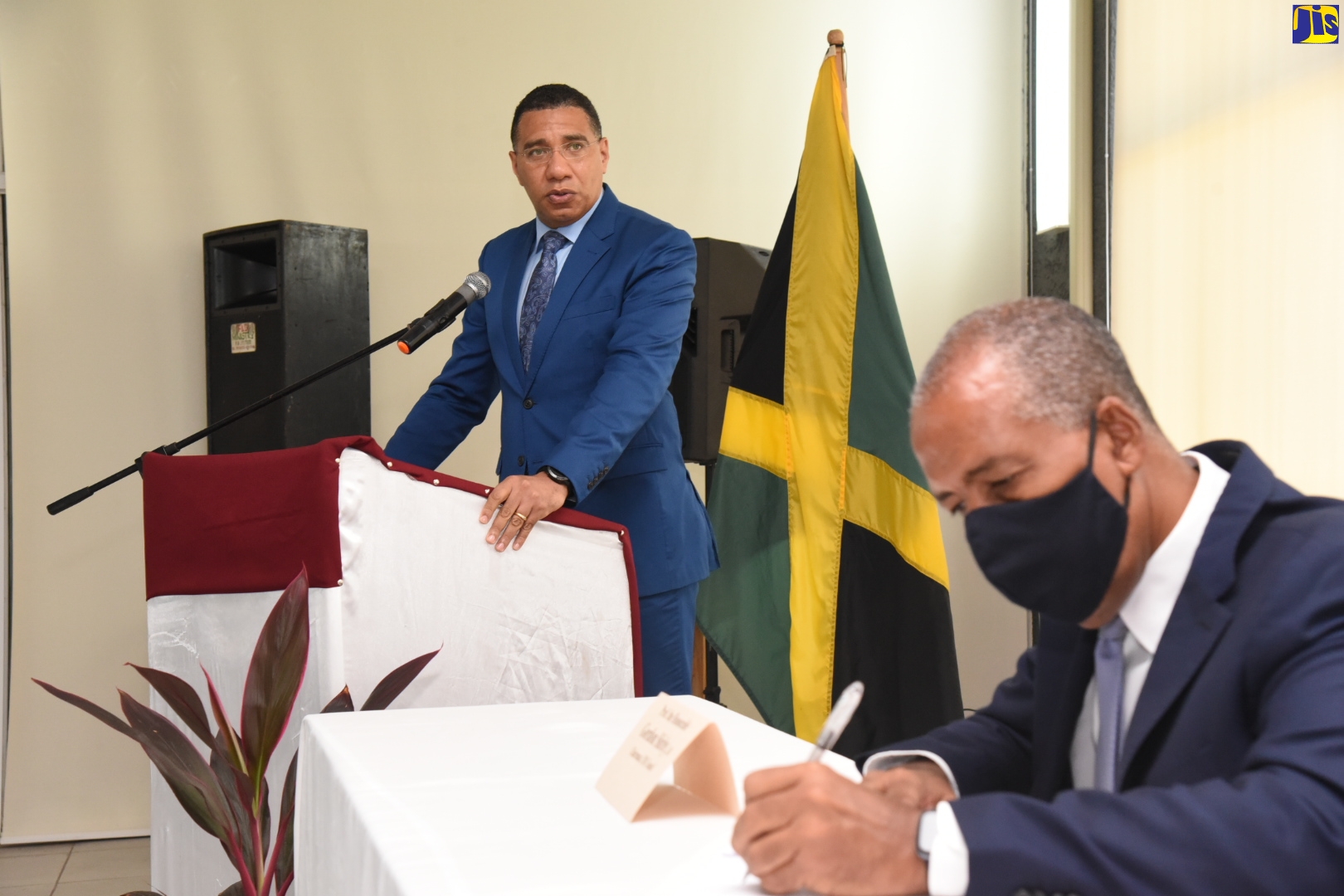 Prime Minister, the Most Hon. Andrew Holness (left), addresses the Caribbean Maritime University (CMU) Council members during a meeting on the campus in Kingston, on Wednesday (June 17). Seated is President and Chief Executive Officer, Port Authority of Jamaica, Professor Gordon Shirley, who is Chairman of the Council.