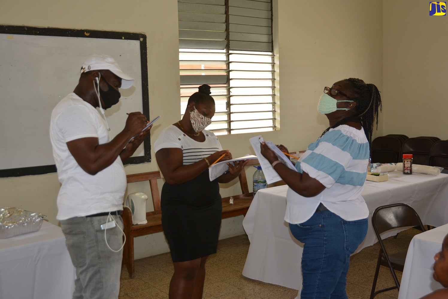 New shelter managers (from left) Fitzdale Roye, Aldelcia Baker and Cordelyn Campbell conduct an inspection, during a training exercise held at the St. Matthew