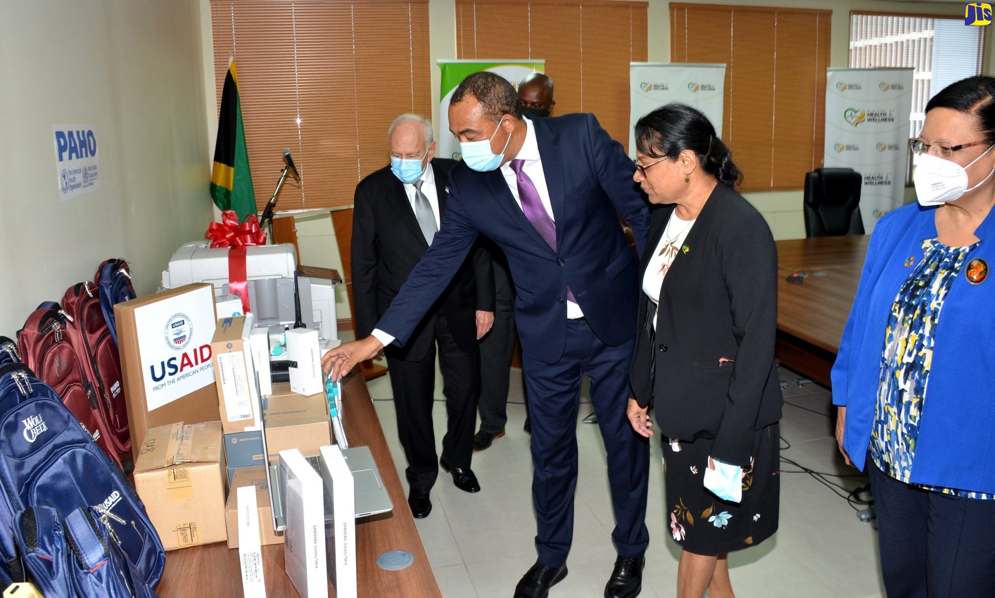 Minister of Health and Wellness, Dr. the Hon. Christopher Tufton  (second left), looks at pieces of equipment donated by the Pan American Health Organization (PAHO) and the United States Agency for International Development (USAID), during a handover ceremony on Tuesday (June 16), at the Ministry’s New Kingston offices in St. Andrew. Looking on (from left) are United States Ambassador to Jamaica, Donald Tapia, Chief Medical Officer (CMO), Dr. Jacquiline Bisasor-McKenzie; and Representative of the Pan American Health Organization (PAHO) to Jamaica, Dr. Bernadette Theodore-Gandi.