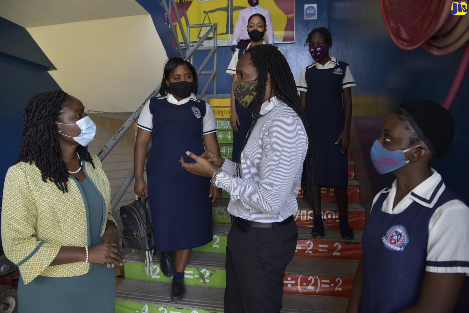 Minister of State in the Ministry of Education, Youth and Information, Hon. Alando Terrelonge (centre), converses with Principal of the Cedar Grove Academy in Portmore, St. Catherine,  Lacey-Ann Blake (left), while students at the institution look on. The State Minister visited the institution on Monday (June 8).