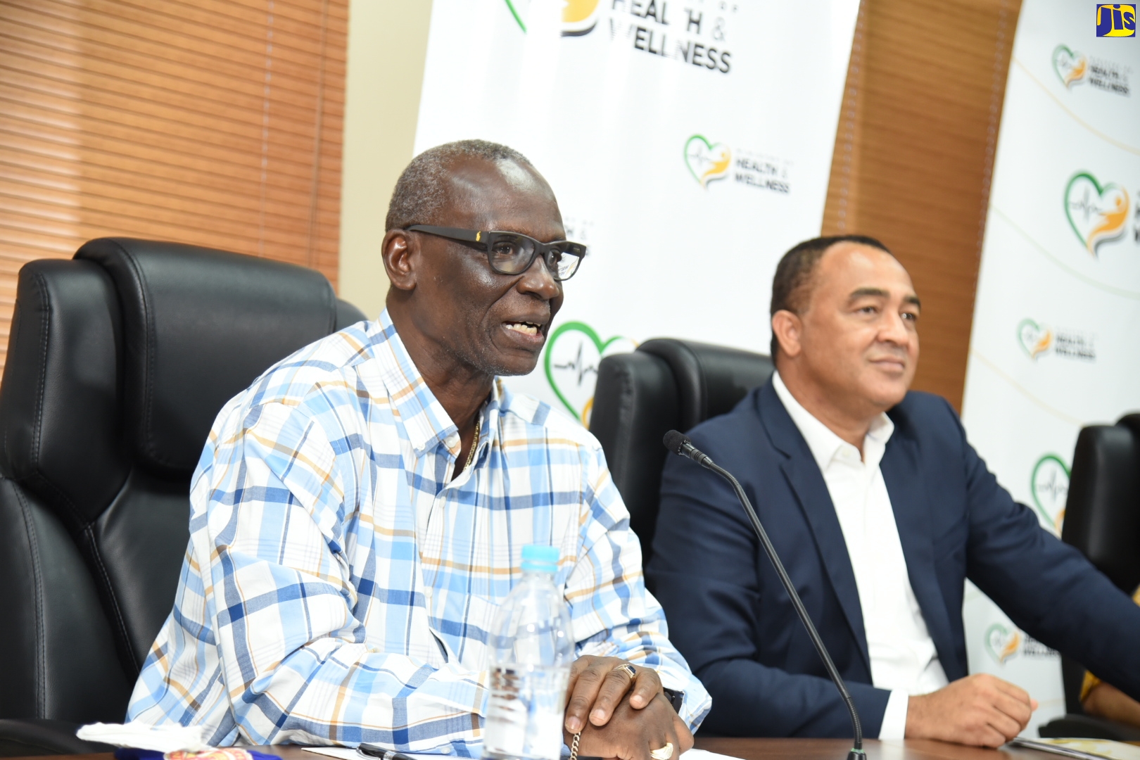 Minister of Local Government and Community Development, Hon. Desmond  McKenzie (left), speaking on Thursday (July 16), during the Ministry of Health and Wellness