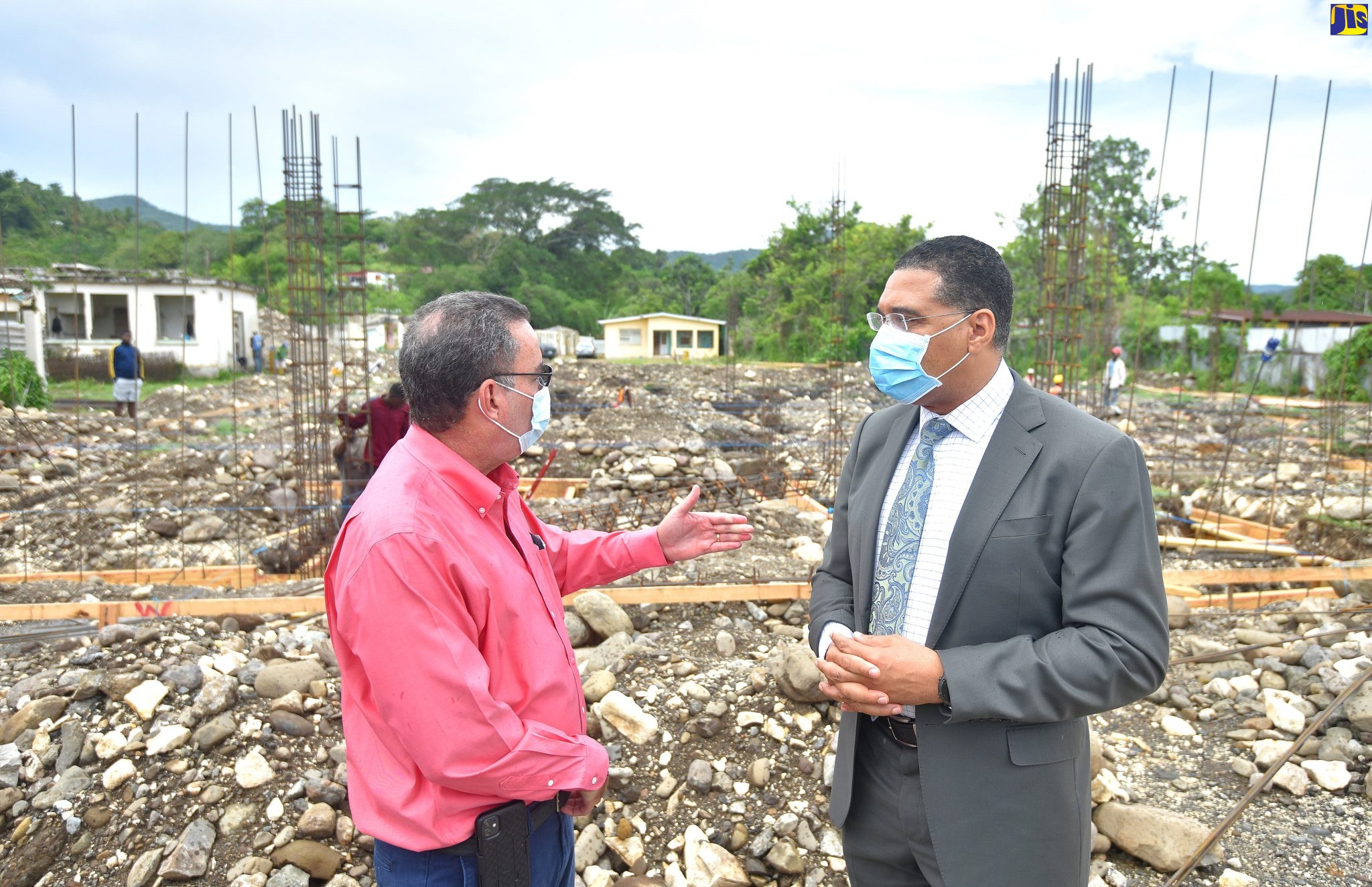 Prime Minister, the Most Hon. Andrew Holness (right), speaking with Minister without Portfolio in the Ministry of Economic Growth and Job Creation and Member of Parliament, Portland Western, Hon. Daryl Vaz, at the construction site for the $200-million state-of the-art Buff Bay Health Centre in Portland. Ground was broken for the project in June.