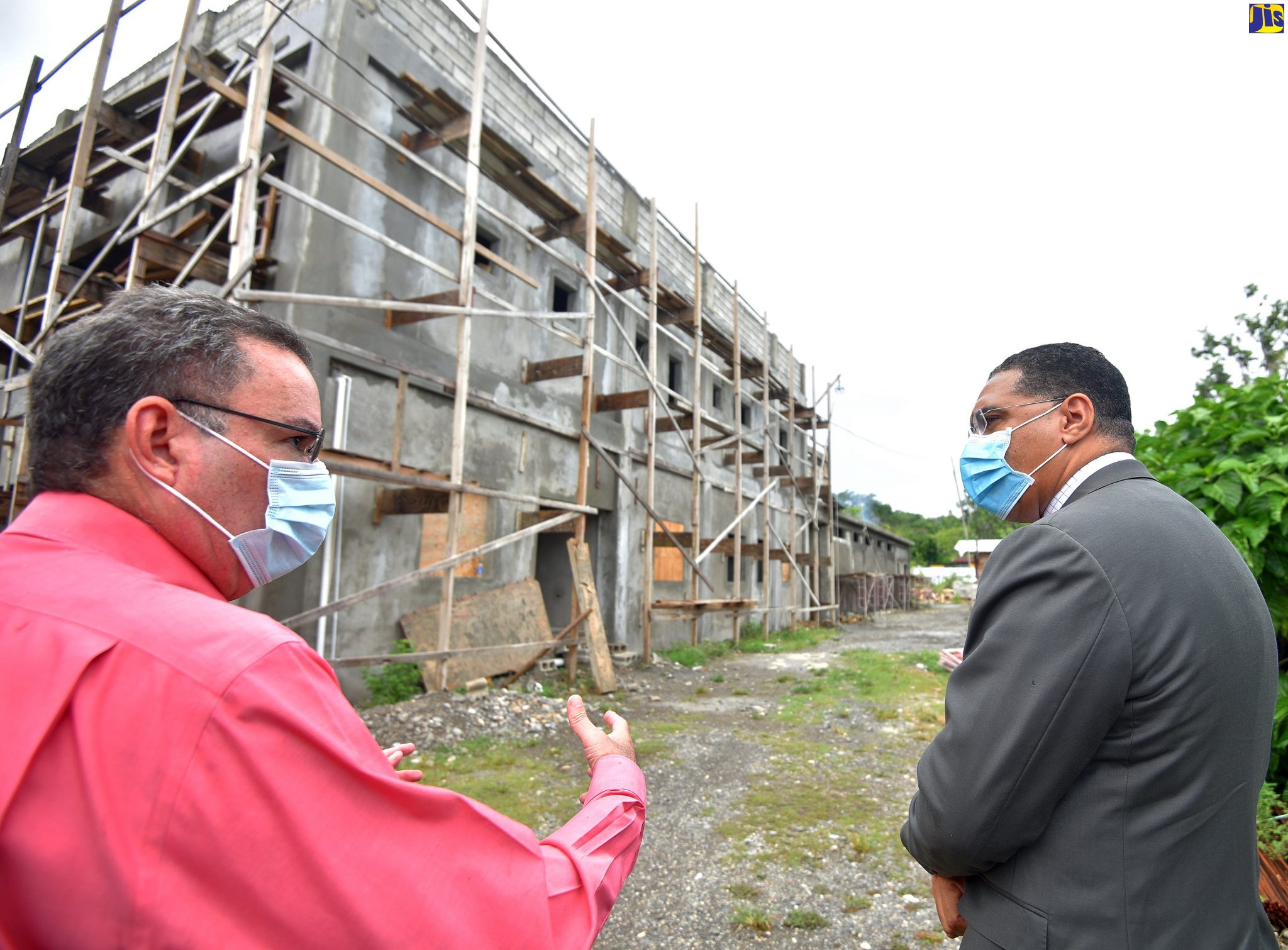 Prime Minister, the Most Hon. Andrew Holness (right), listens to a point from Minister without Portfolio in the Ministry of Economic Growth and Job Creation and Member of Parliament, Portland Western,  Hon. Daryl Vaz, during a tour of the construction site for the new Buff Bay Police Station in Portland on Friday (July 24).