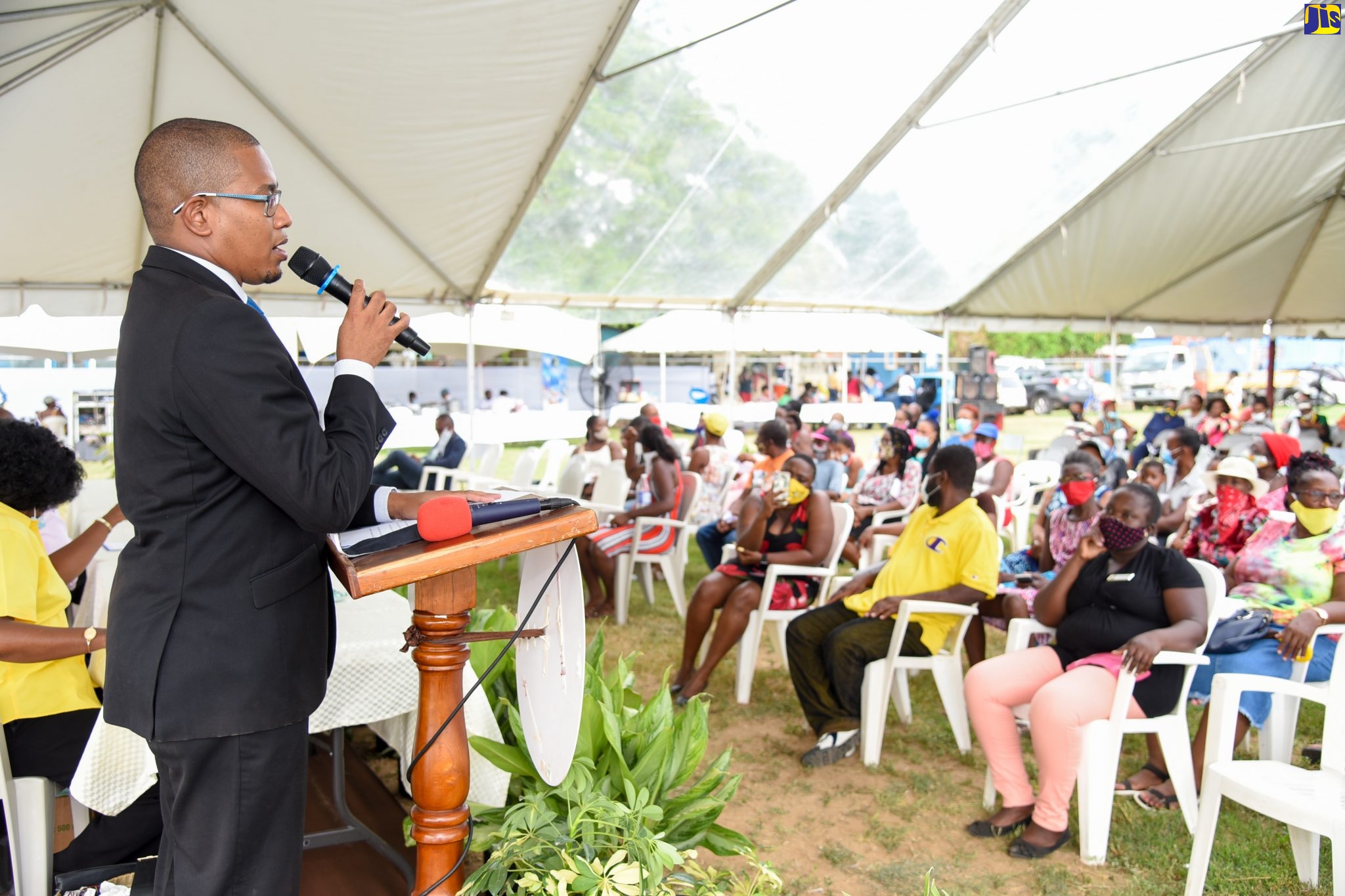 Minister of State in the Ministry of Industry, Commerce, Agriculture and Fisheries, Hon. Floyd Green, addresses a community meeting at the Clifton Playfield in St. Catherine on Wednesday (July 15).