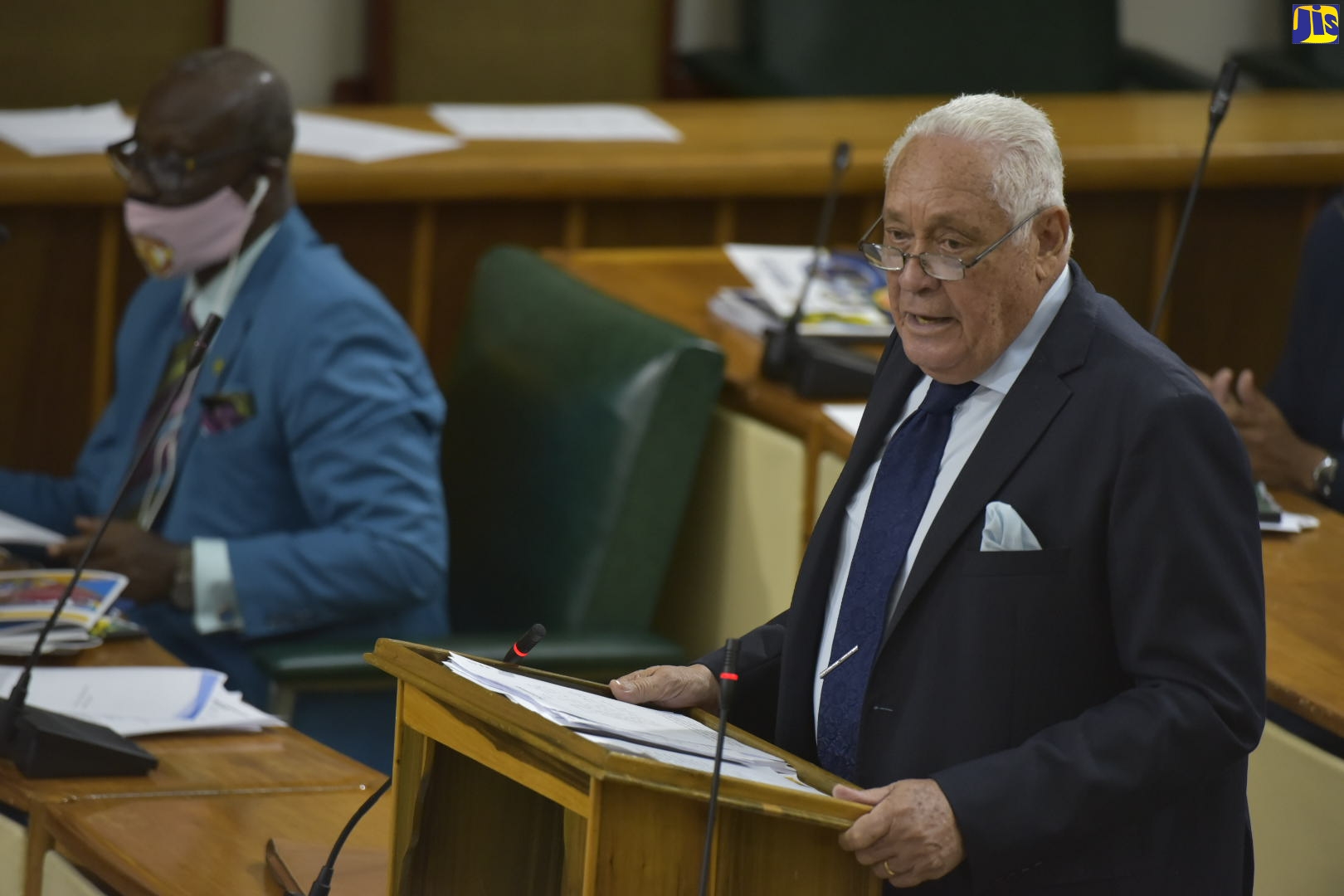 Minister of Labour and Social Security, Hon. Mike Henry, making his contribution to the 2020/21 Sectoral Debate in the House of Representatives on July 21. At left is Minister of Local Government and Community Development, Hon. Desmond McKenzie.