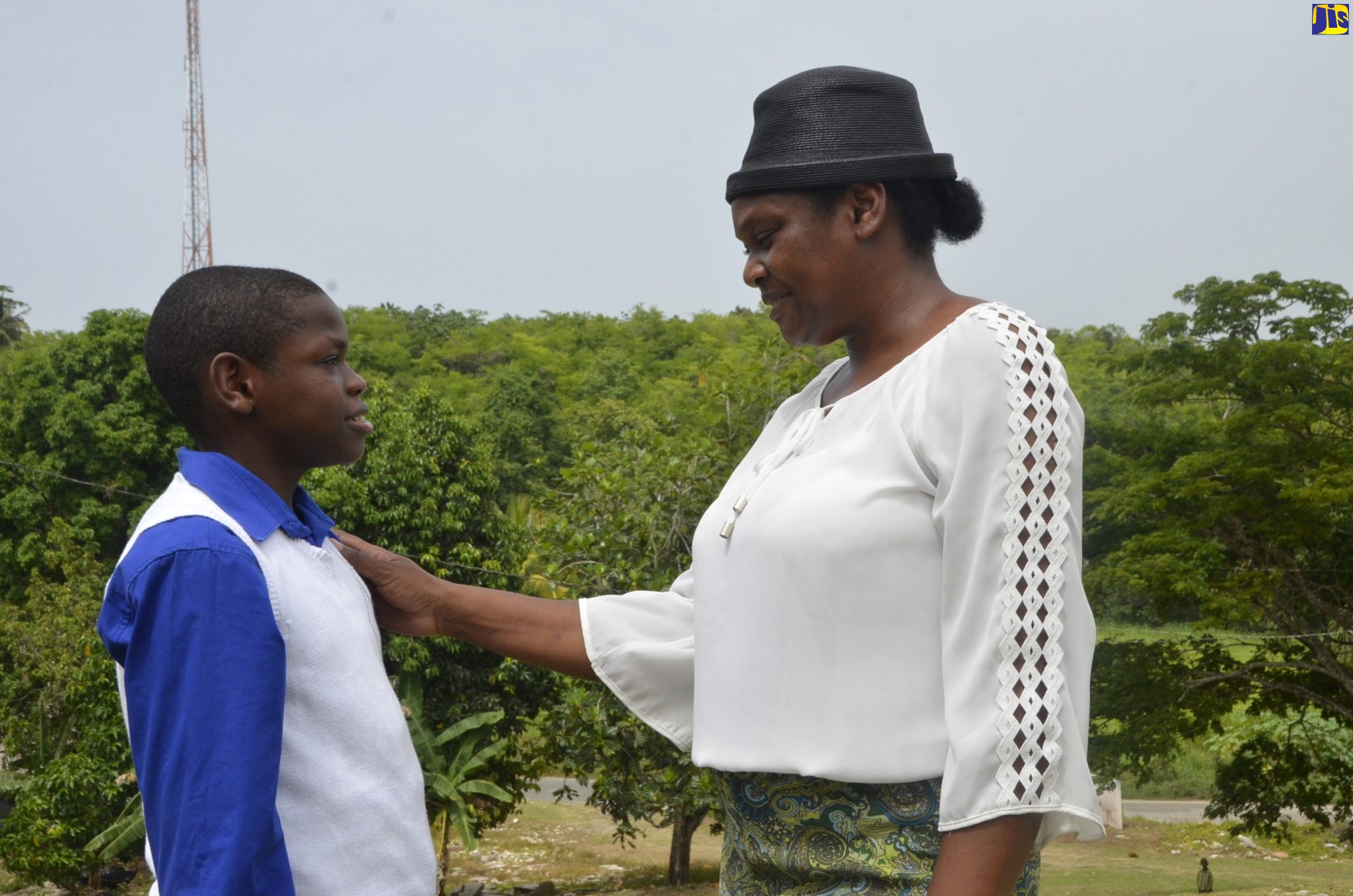 Keville Cunningham Jr. (left) in dialogue with proud mom, Racquel Brown-Cunningham. Keville was placed at Cornwall College in St. James after being successful in his Primary Exit Profile (PEP) exams.
