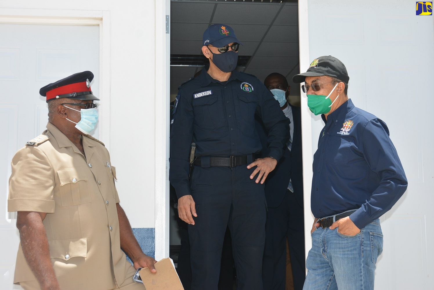 Minister of National Security,  Hon. Dr. Horace Chang (right), in discussion with Commissioner of Police, Major General Antony Anderson; and Inspector of Police, Stephen Sharpe (left),  during a tour of the Jamaica Constabulary Force (JCF) training facility at Tranquility Bay in St. Elizabeth, on July 3.