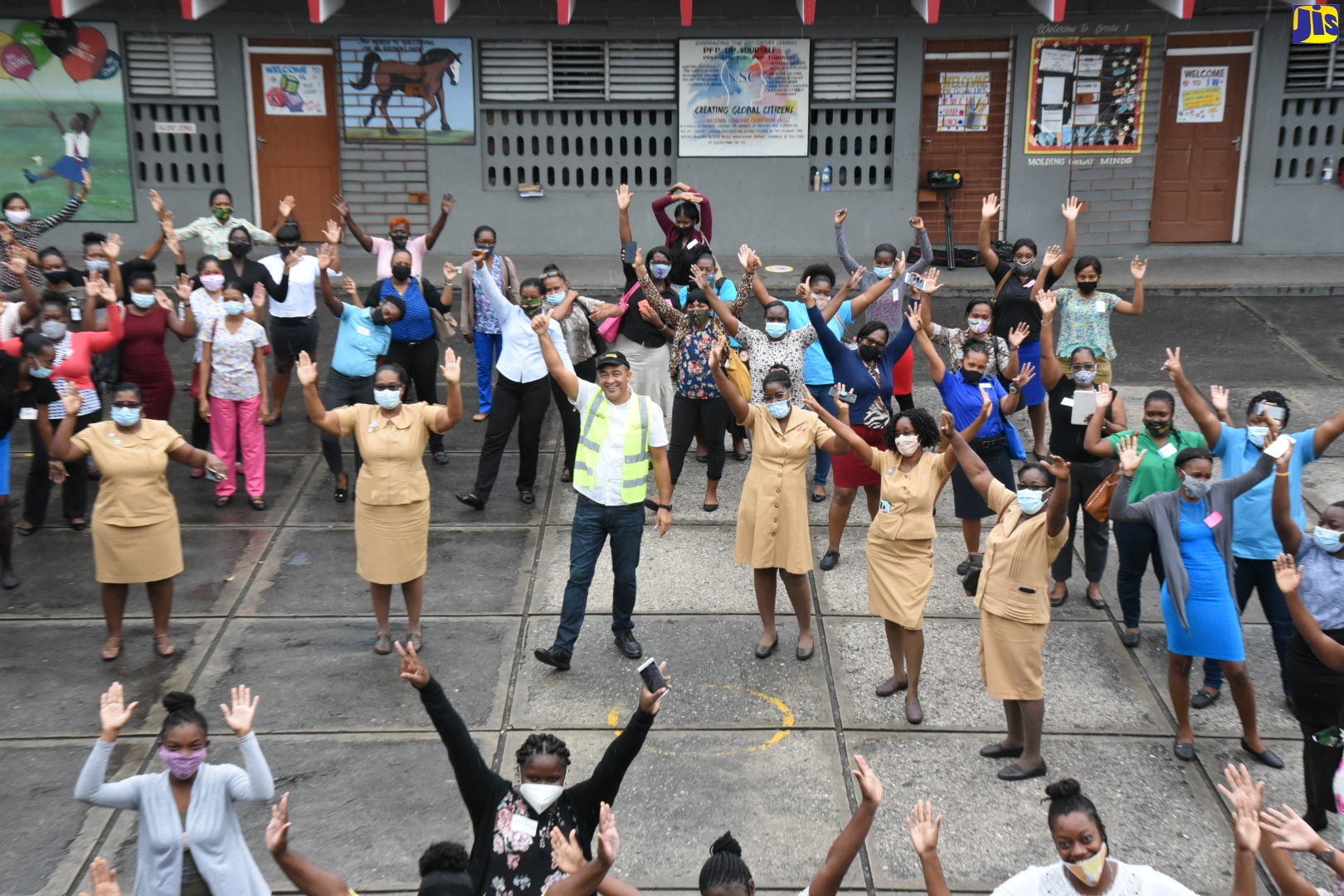 Minister of Health and Wellness, Dr. the Hon. Christopher Tufton (centre), with community health aides, who are being trained as part of the coronavirus (COVID-19) response. The community health aide training session was held at the Half-Way Tree Primary School on July 23.