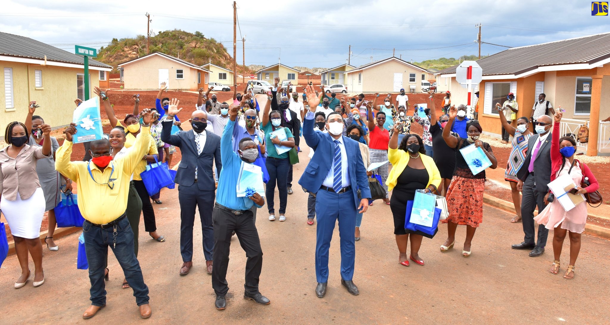 Prime Minister, the Most Hon. Andrew Holness (front, centre), celebrates with new homeowners at the St. Catherine-based SilverSun Estates, on Wednesday (July 1).