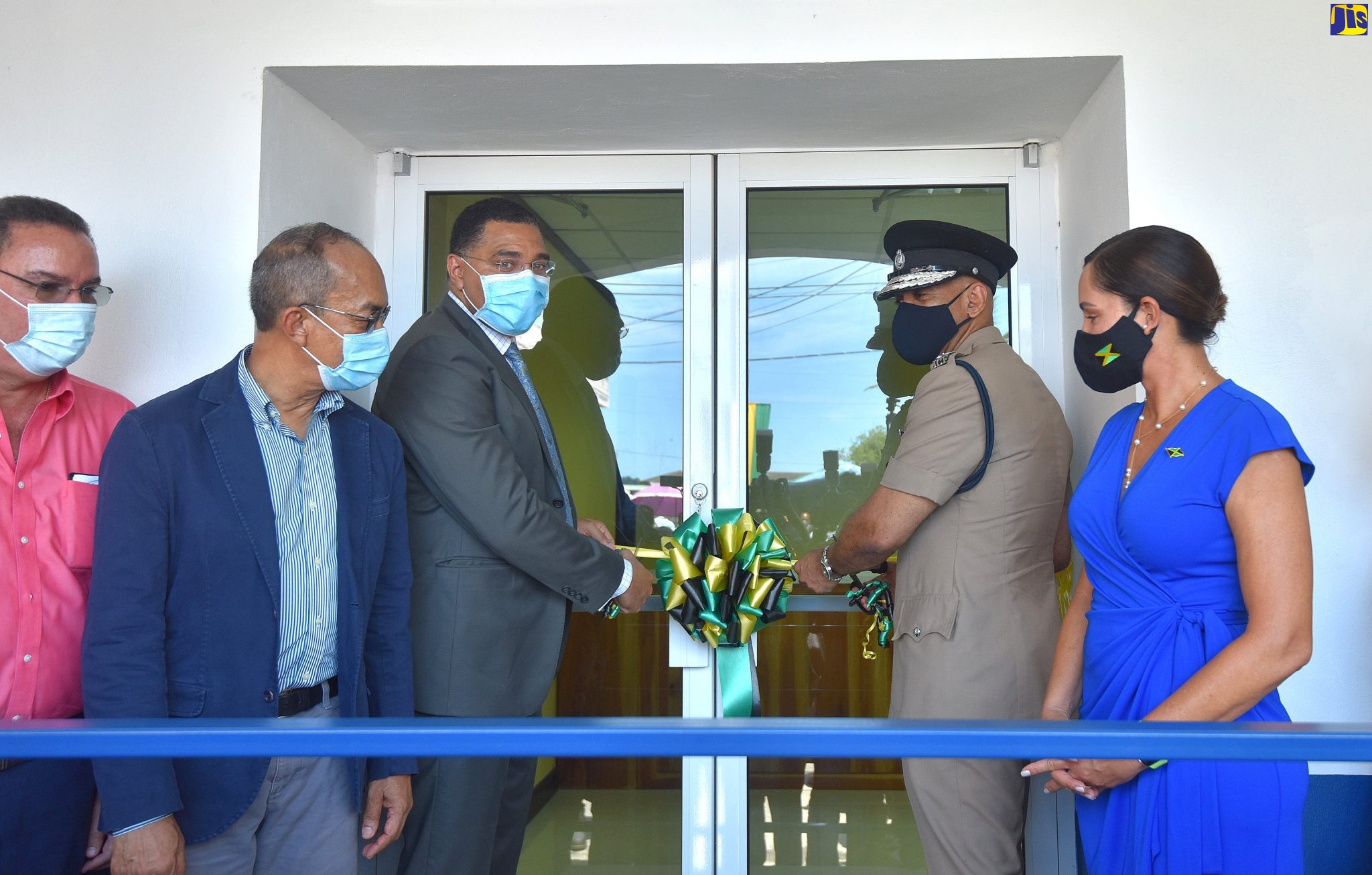 Prime Minister, the Most Hon. Andrew Holness (centre); and Commissioner of Police, Major General Antony Anderson (second right) cuts the ribbon to officially open the renovated Port Antonio Police Station and Portland Divisional Headquarters on Friday (July 24). Witnessing the occasion (from left) are Minister without Portfolio in the Ministry of Economic Growth and Job Creation and Member of Parliament, Portland Western, Hon. Daryl Vaz; Minister of National Security, Hon. Dr. Horace Chang; and Member of Parliament, Portland Eastern, Ann-Marie Vaz.