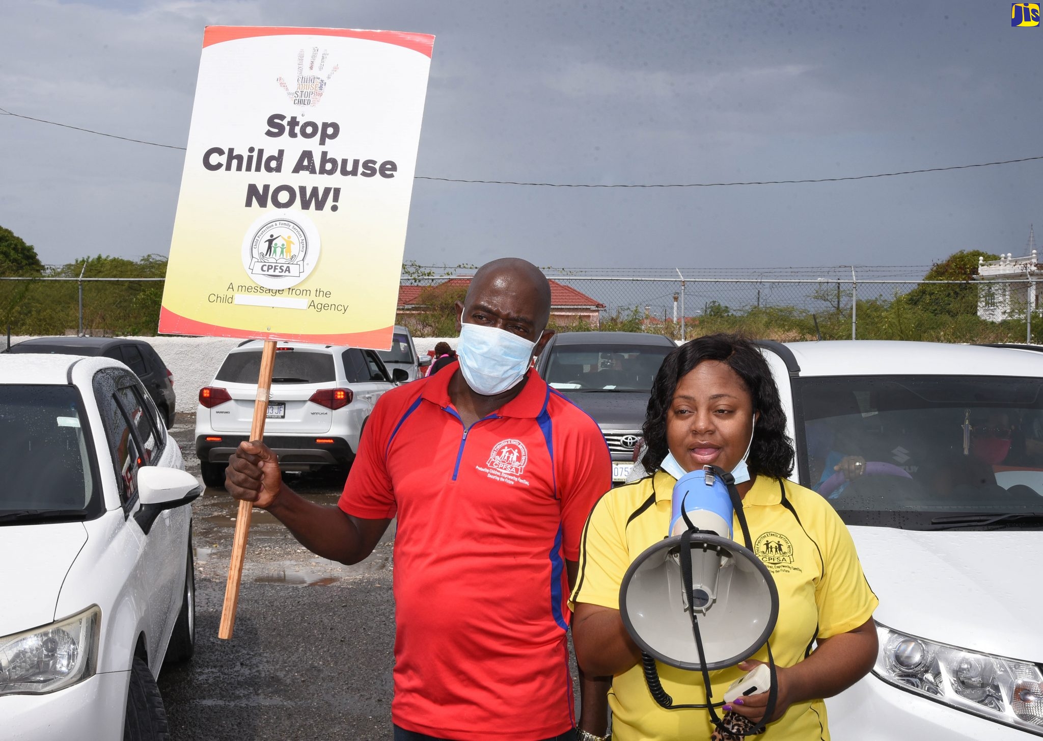 Child Protection and Family Services Agency (CPFSA) South East Regional Director, Robert Williams (left), raises a