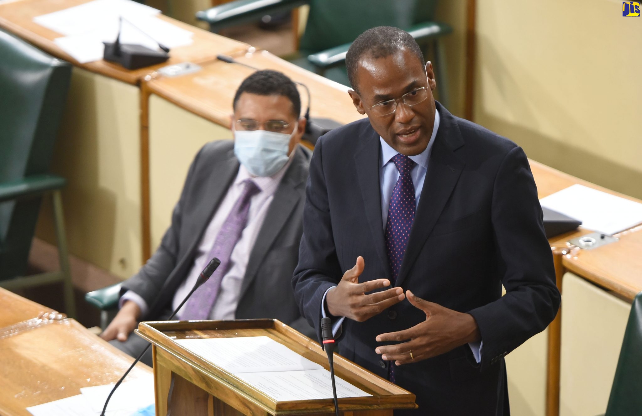 Minister of Finance and the Public Service, Dr. the Hon. Nigel Clarke, makes a statement in the House of Representatives on July 7. Seated at left is Prime Minister, the Most Hon. Andrew Holness.