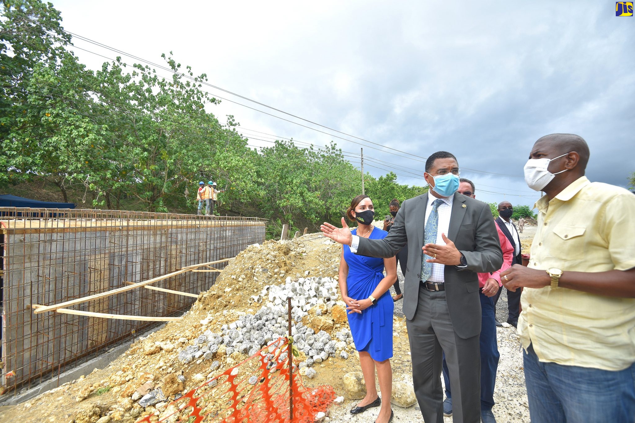 Prime Minister, the Most Hon. Andrew Holness (centre), converses with Senior Director, Project Implementation, National Works Agency (NWA), Varden Downer (right), during a tour of the Southern Coastal Highway Improvement Project (SCHIP) in Portland on Friday (July 24). Listening is Member of Parliament, and Eastern, Ann-Marie Vaz.