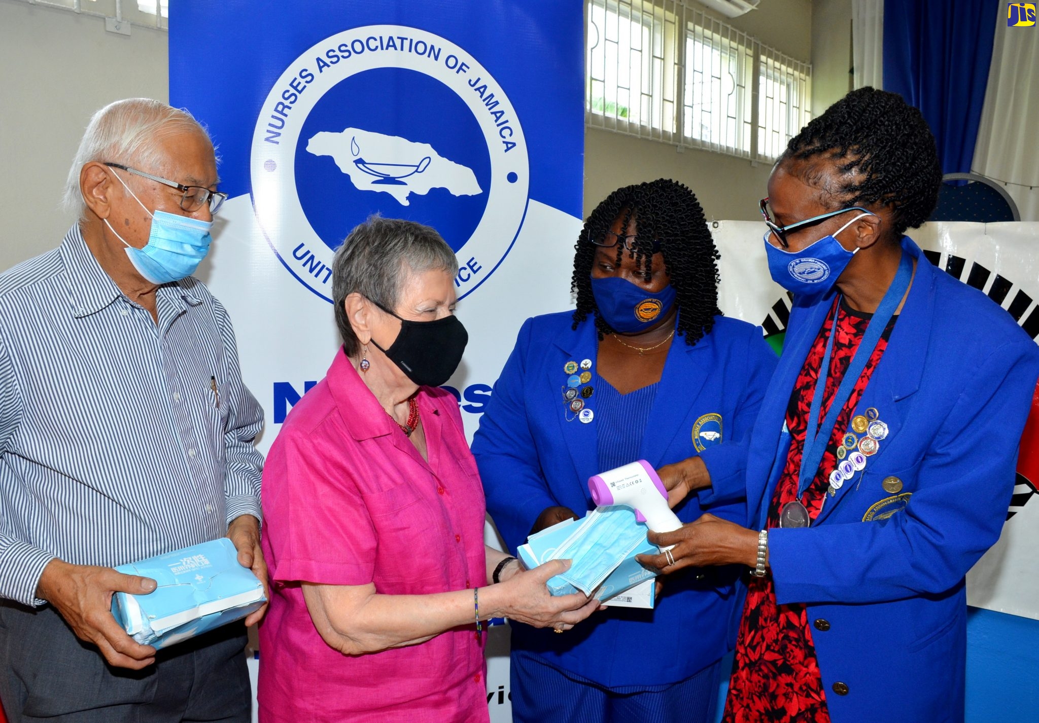 President of Nurses Association of Jamaica (NAJ), Carmen Johnson (right), and NAJ Third Vice-President, Nancy Davis-Williams, are presented with personal protective equipment and other medical supplies by President of the Jamaica Chinese Friendship Association (JCFA), Irena Cousins (second left). The provisions include 200 infra-red thermometers and 200 facemasks for use by the nurses in the fight against the Coronavirus Disease 2019 (COVID-19) pandemic in Jamaica. The presentation was made during a brief ceremony at the NAJ’s head office in Kingston, on Friday (July 24). Looking on is JCFA Vice-President, Wilson Look Kin. The masks were donated by the Embassy of the People’s Republic of China in Jamaica and the Chinese People’s Association for Friendship with Foreign Countries (CPAFFC) in Beijing. The CPAFFC is the JCFA’s parent body. The donation was also made possible through the JCFA’s COVID-19 fund raising drive.