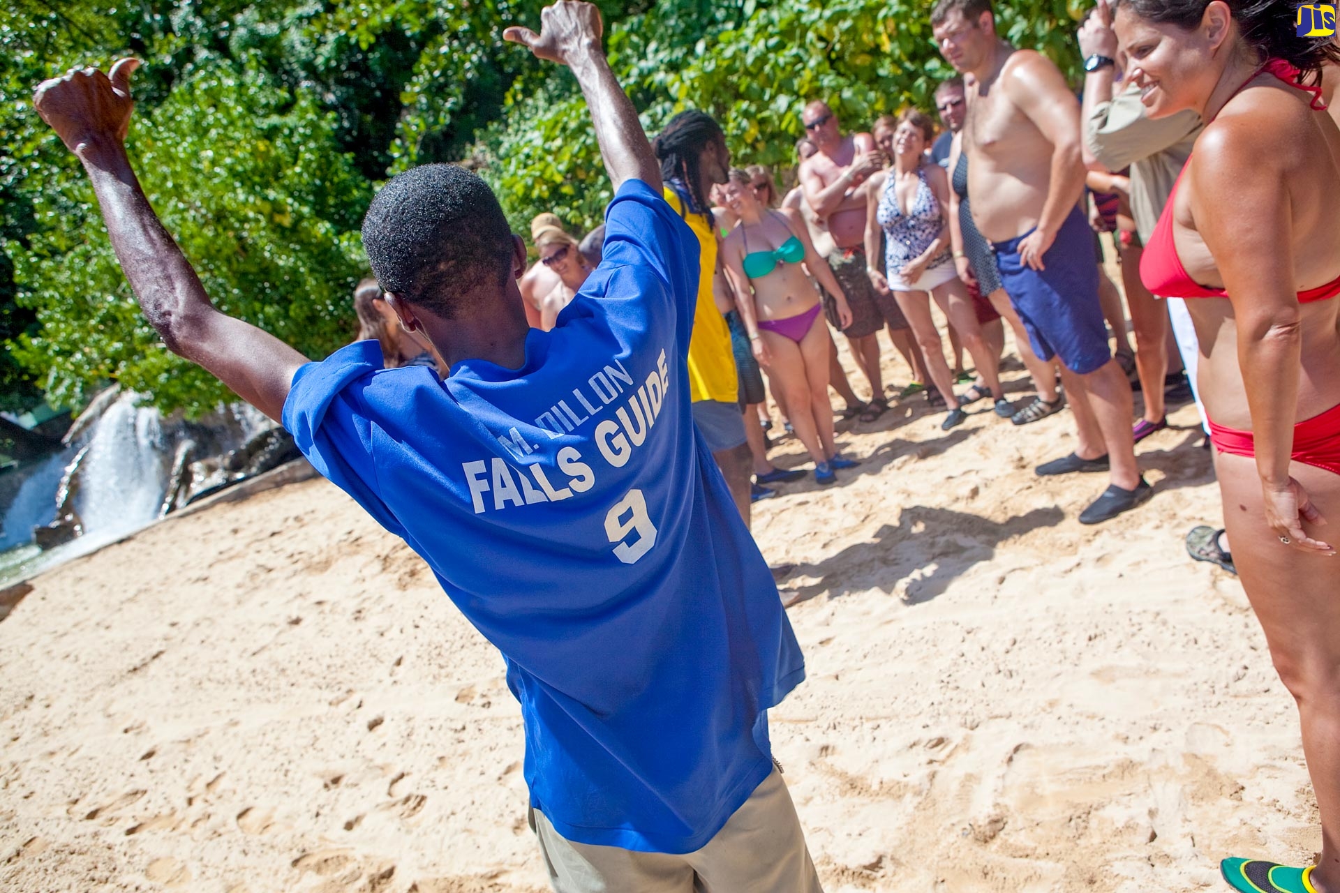 A tour guide (left) at Dunn’s River Falls in Ocho Rios, St. Ann, provides guests with last minute instructions prior to their trekking up the falls.