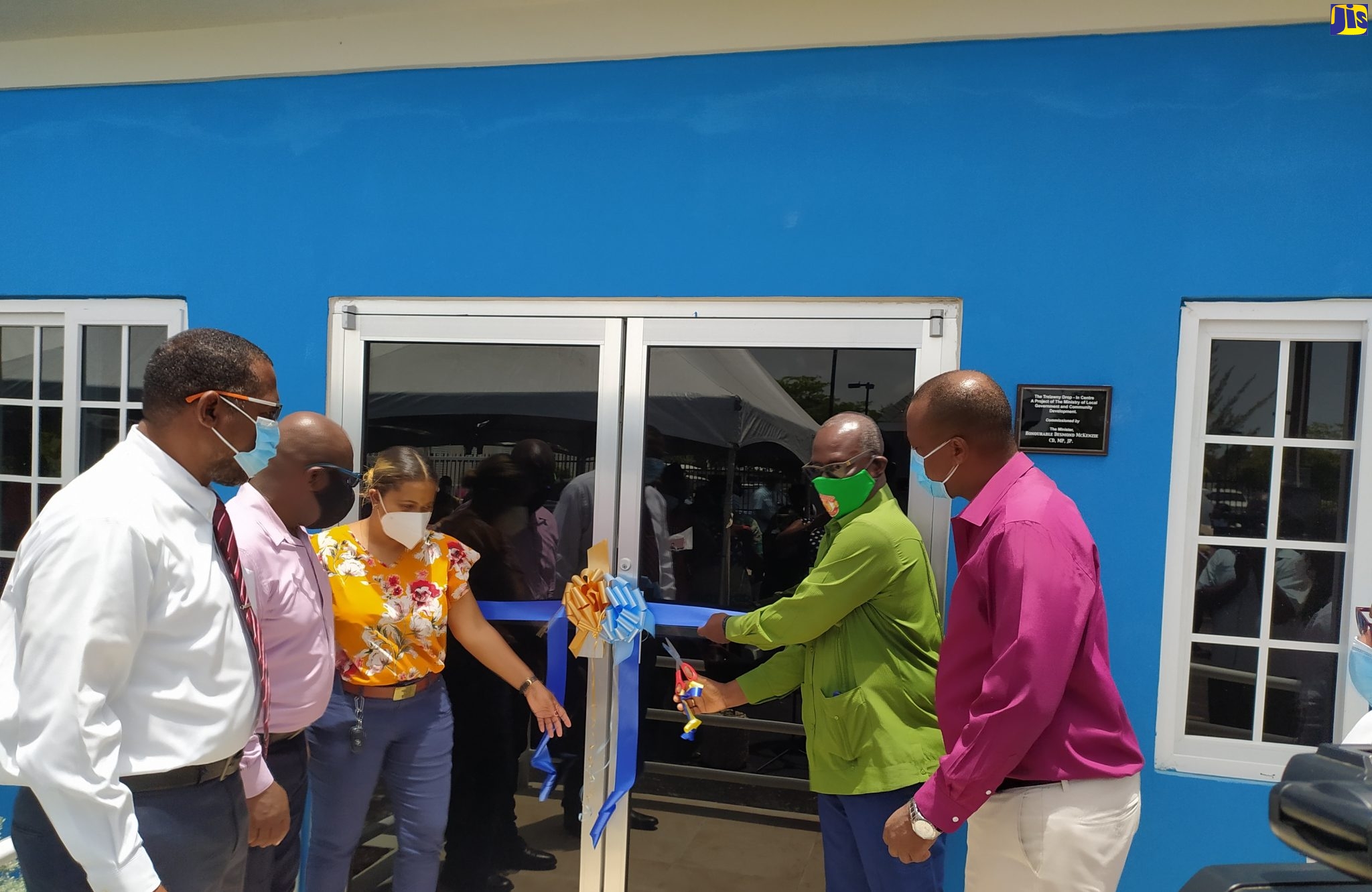 Minister of Local Government and Community Delevopment, Hon. Desmond McKenzie (second right), cuts the ribbon to open the Trelawny Drop-In Centre in Falmouth on July 15. Looking on ( from left) are former Mayor of Falmouth, Garth Wilkinson; Mayor Colin Gager; Secretay, Board of Supervision, Treka Lewis; and Member of Parliament for North Trelawny, Victor Wright.