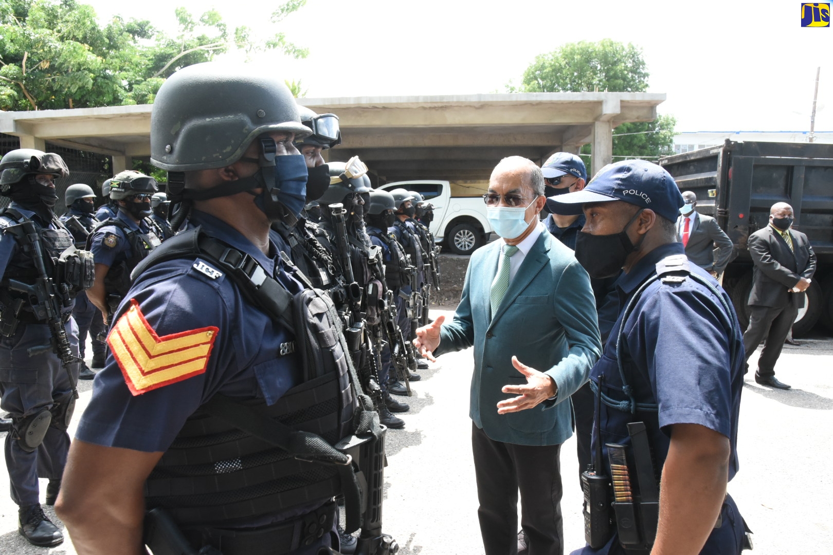 Minister of National Security, Hon. Dr. Horace Chang (second right), inspects members of the Jamaica Constabulary Force (JCF) Special Weapons and Tactics (SWAT)  team with Acting Head, SWAT, Inspector Anthony Wallace (right), during a tour of the Harman Barracks facility in St. Andrew, on August 4.