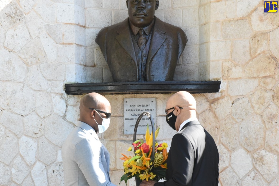 Governor- General, His Excellency the Most Hon. Sir Patrick Allen (right), receives a floral arrangement from aide- de- camp, Major Fenekie Rowe, to be placed at the shrine of Jamaica’s first National Hero, the Right Excellent  Marcus Garvey, during a ceremony to commemorate the 133rd anniversary of his birth. The ceremony was held on Monday (August 17) at National Heroes Park, in Kingston.