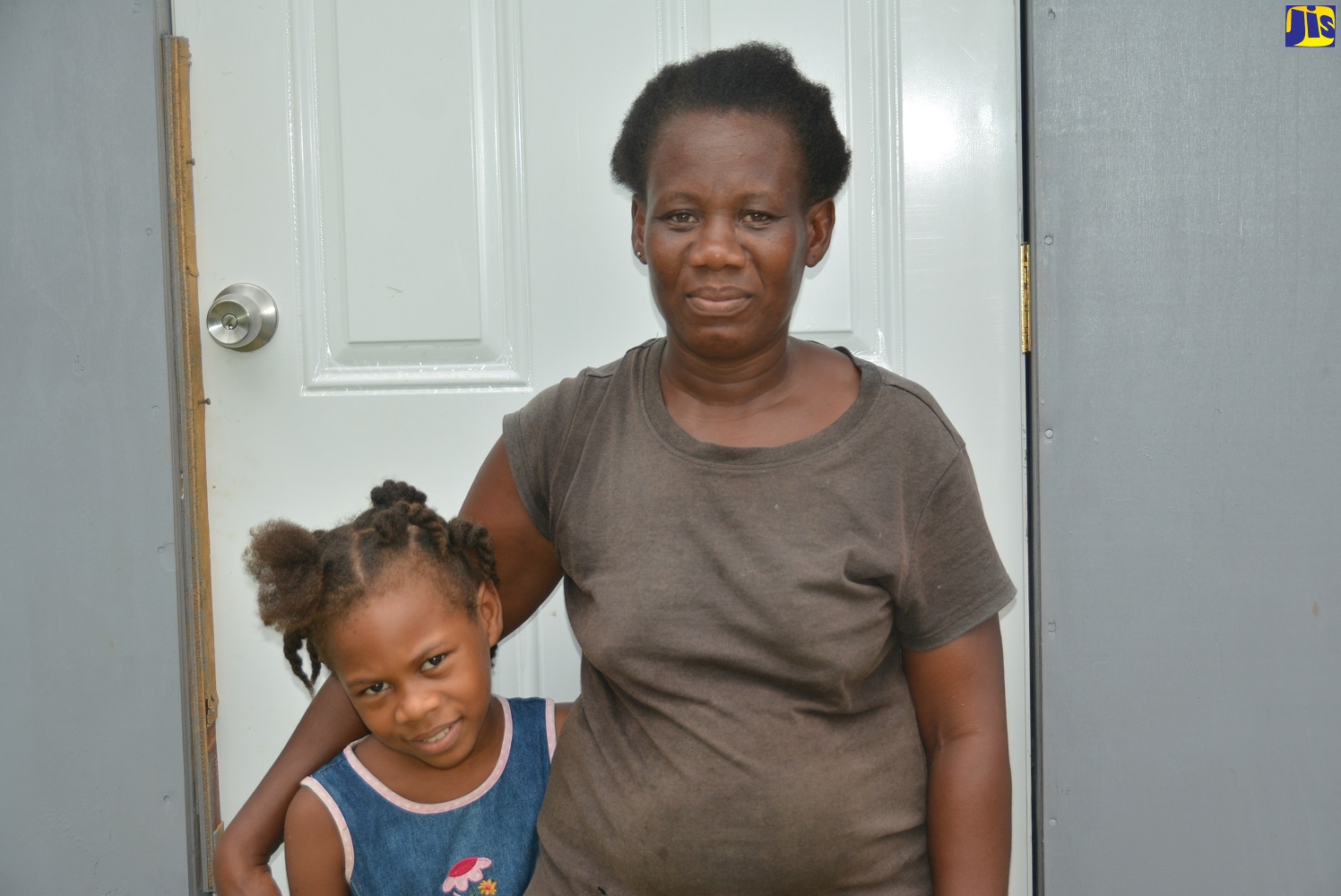 Resident of Miles Town District in Hanover, Sylvia Graham, and her daughter, Jamilia Martin,  at the entrance to the new room built by the Hanover Poor Relief Department and handed over recently to the family.

 