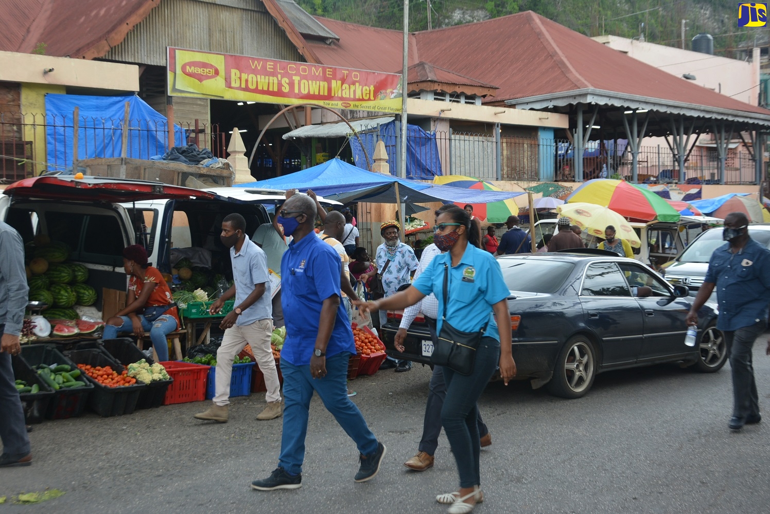 Minister of Local Government and Community Development, Hon. Desmond McKenzie (in front), tours  the Brown’s Town Market in St. Ann on Tuesday, August 4.