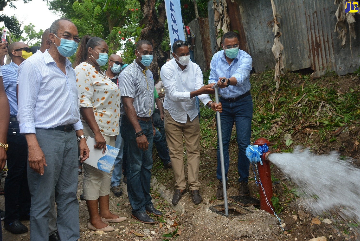 Prime Minister, the Most Hon. Andrew Holness (right), turns on the main water valve in Claremont, Hanover, to officially commission into service the $400 million Claremont to Jericho Water Supply System, on Saturday, August 8. Sharing in the moment are (from left): Minister of National Security, Hon. Dr. Horace Chang; Councillor Caretaker for Sandy Bay Division, Maverine Brown; President of the National Water Commission, Mark Barnett; and Member of Parliament for Hanover Eastern, Dave Brown.