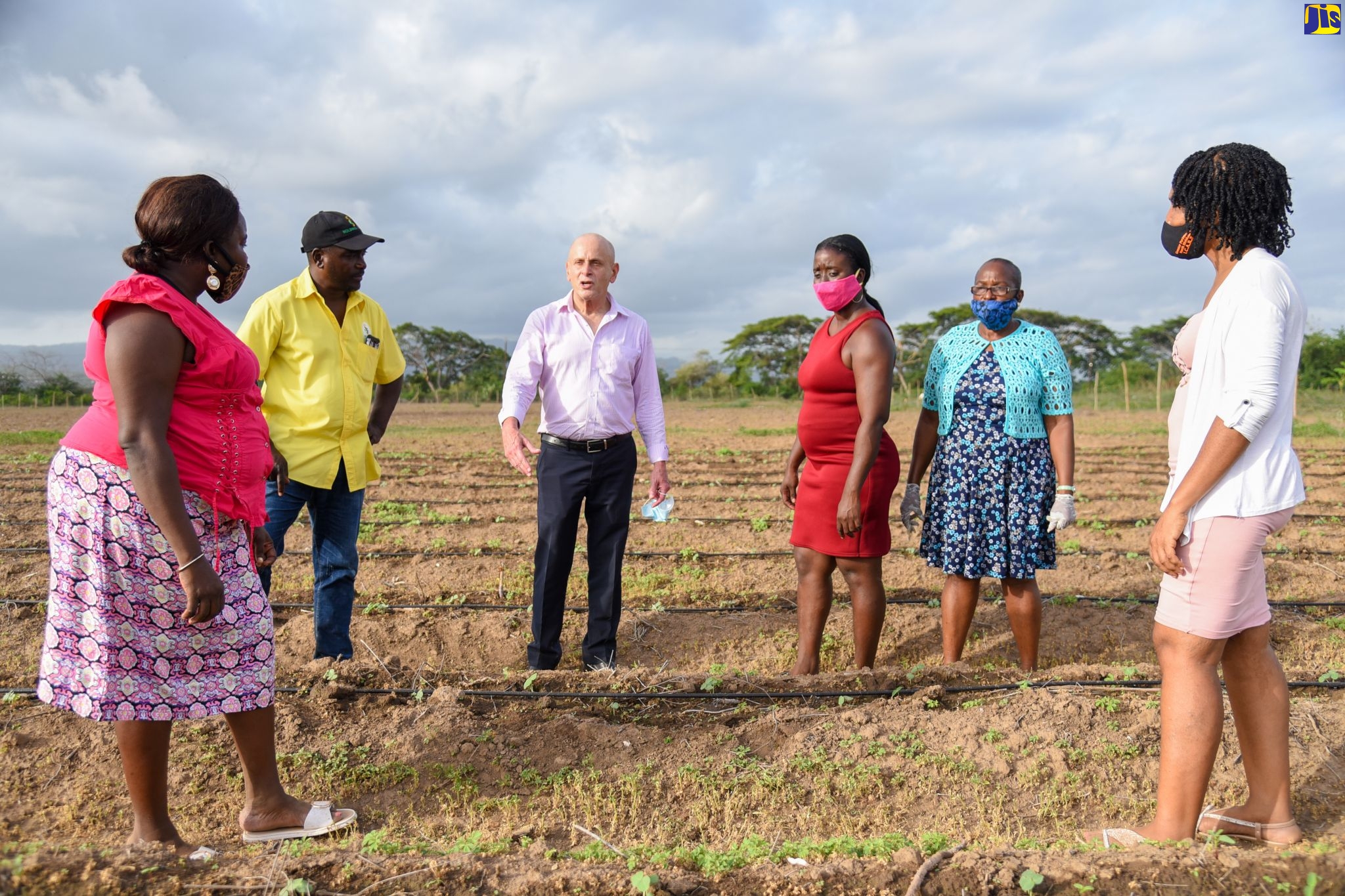 Managing Director of the Sugar Company of Jamaica Holdings Limited (SCJH), Joseph Shoucair (third left) and Property Warden with the agency, in discussion with operators of a community farm in Clifton, St. Catherine, during a recent community event. The farm was established on lands donated by the SCJH and run by mainly women.