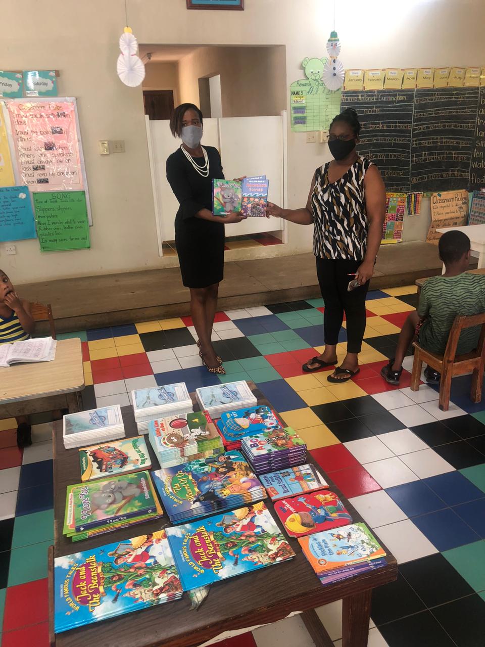 President of the Kiwanis Club of Montego Bay, Teisha-Ann Pinnock (left), presents storybooks to Principal of Maffessanti Basic School in Unity Hall, St. James, Anthonette Allen (rigt), as part of an initiative by the Club to improve the literacy outcomes of students at the institution.



