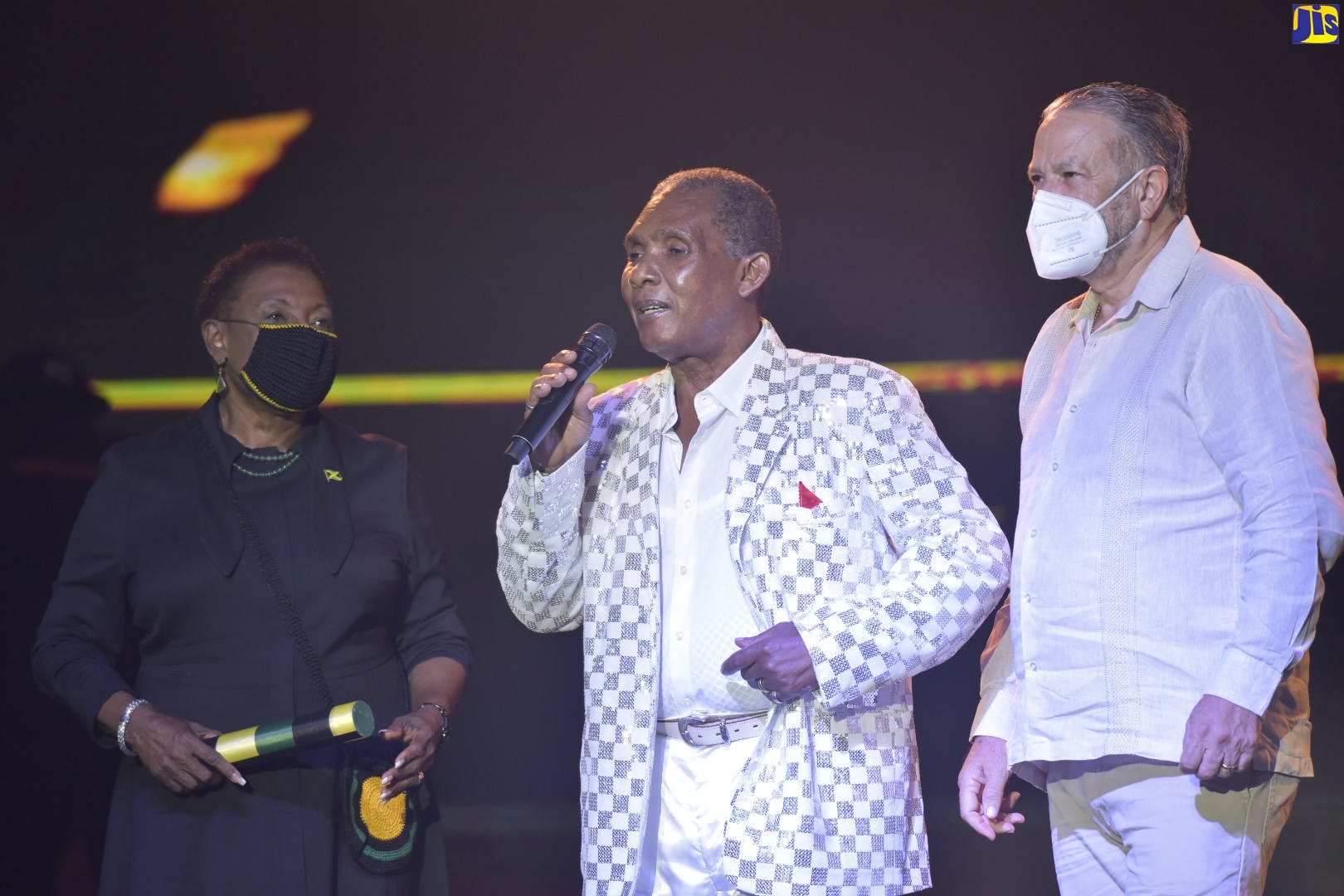 Outstanding Jamaican vocalist, Ken Boothe (centre), gives thanks after being being presented with a Reggae Icon Award at the 2020 Independence Day celebrations, held inside the National Arena on Thursday (August 6). Sharing  the moment are Minister of Culture, Gender, Entertainment and Sport,  Hon. Olivia Grange (left) and President of the Senate, Senator, the Hon. Tom Tavares-Finson.