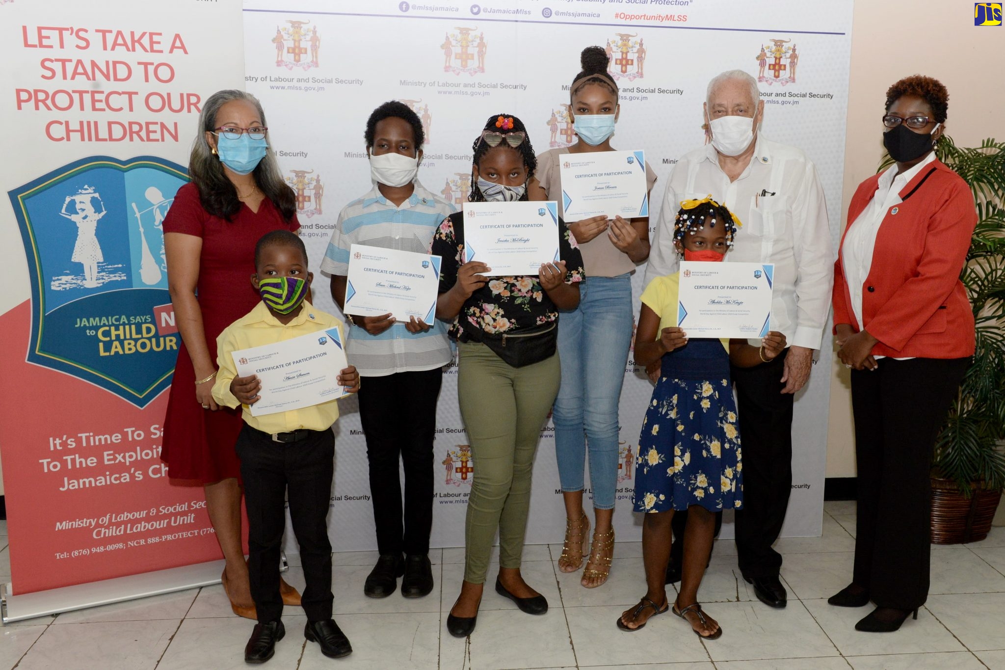 Minister of Labour and Social Security, Hon. Mike Henry (second right), along with Permanent Secretary in the Ministry, Colette Roberts-Risden (second left) and Director of Child Labour, Sasha Deer-Gordon (right), shares a photo opportunity with the winners and runners-up in the Child Labour Essay Competition, at the awards ceremony at the Ministry in downtown Kingston on Thursday (July 30). The winners and runners-up are (from left) Amir Simon, Sean-Michael Hope, Jeneika McBright, Jorian Brown and Akalia Mckenzie.