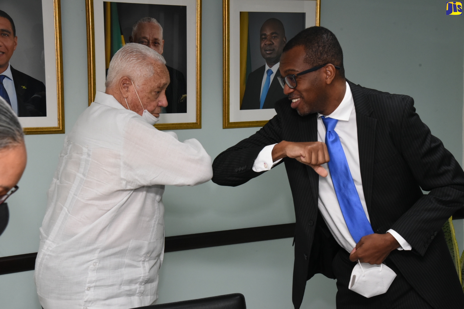 Minister of Labour and Social Security, Hon. Lester Michael Henry (left), greets Consul General Designate of Jamaica to Toronto, Lincoln Downer, on his arrival at the Ministry in downtown Kingston, on July 31