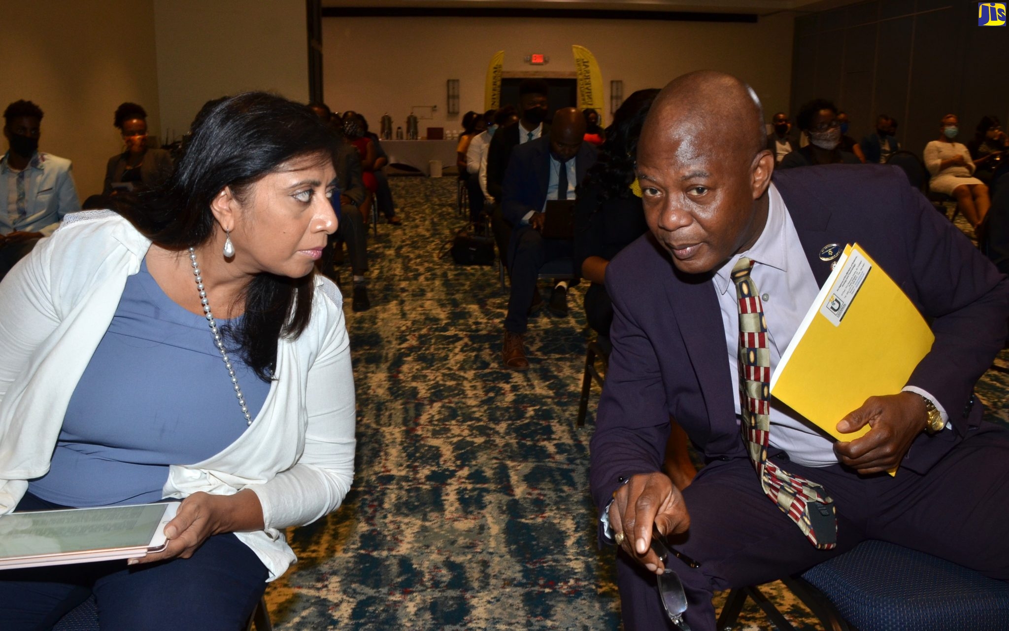 Chief Executive Officer of the Universal Service Fund (USF), Daniel Dawes, converses with Chairperson of the USF Board of Management, Dr. Gunjan Mansingh, during the launch of the USF Tertiary ICT Research Grant Programme, on Wednesday (August 12) at The Jamaica Pegasus hotel in Kingston.