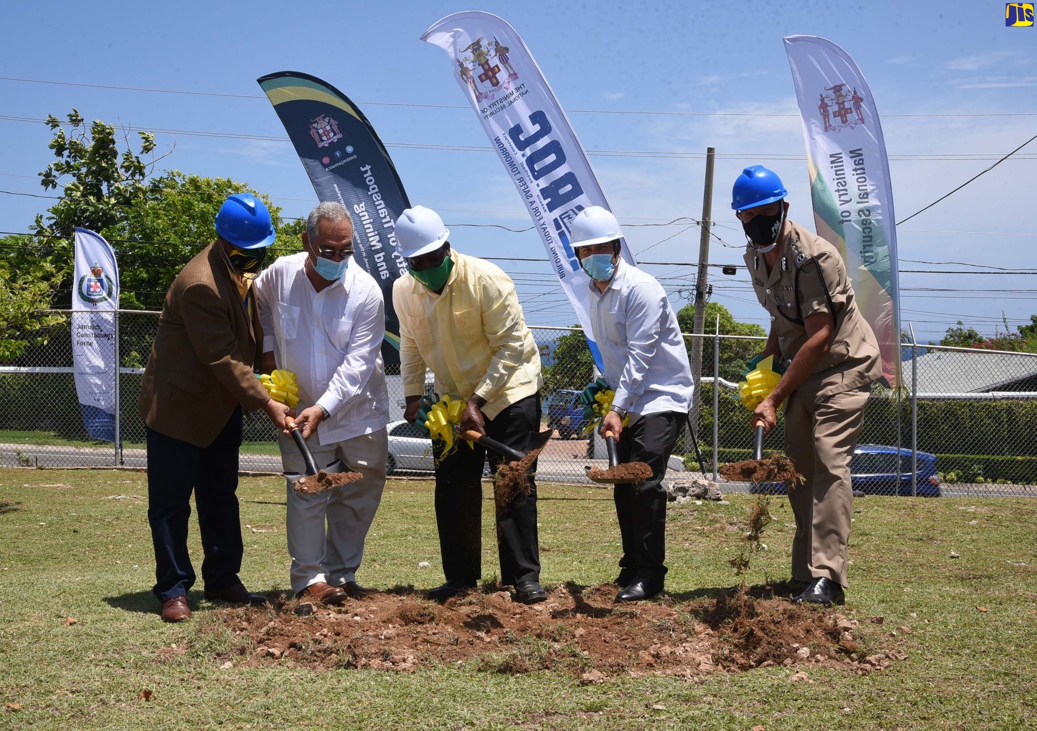 Minister without Portfolio in the Ministry of National Security, Senator the Hon. Matthew Samuda (second right); and Minister of Transport and Mining, Hon. Robert Montague (centre), break ground for the construction of a new police post at the Ian Fleming International Airport in Boscobel, St. Mary, on Friday (August 14). Also taking part (from left) are:President, Airports Authority of Jamaica, Audrey Deidrick; Board Chairman, Airports Authority of Jamaica, William Shagoury; and Deputy Commissioner of Police, Clifford Blake.