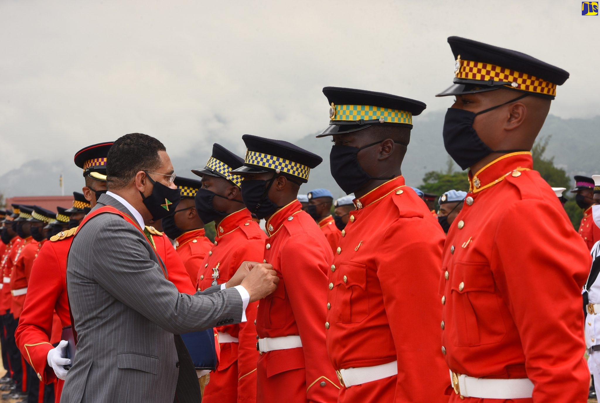 Prime Minister and Minister of Defence, the Most Hon. Andrew Holness, pins a Medal of Honour for General Service on the lapel of Jamaica Defence Force (JDF) member, Private R. Tyrell, during the JDF’s Armed Forces Day Parade at Up Park Camp, Kingston, on Friday (July 31).