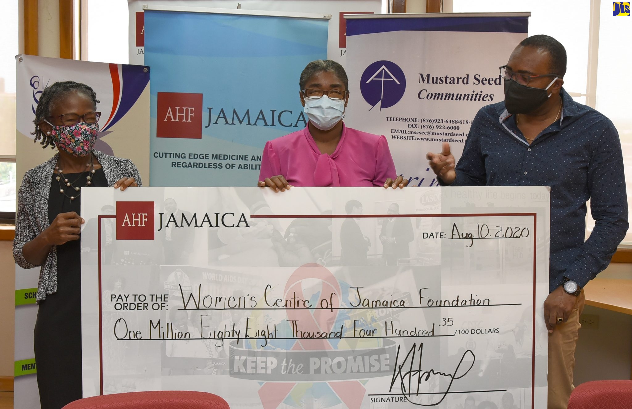Regional Director, AIDS Healthcare Foundation (AHF), Dr. Kevin Harvey (right) presents a cheque valued at just over $1 million to Executive Director of the Women’s Centre of Jamaica Foundation (WCJF), Dr. Zoe Simpson (left) and Field Operations at the WCFJ, Beverley Martin Berry, at the AHF’s offices in St. Andrew, on August 10. The money will be used to support the WCJF