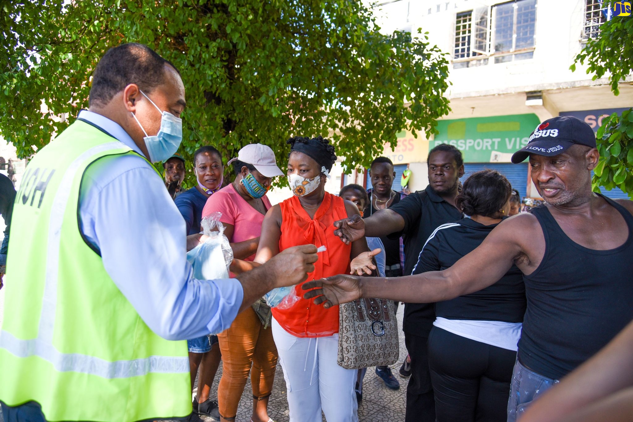 Minister of Health and Wellness, Dr. the Hon. Christopher Tufton (left), distributes masks to members of the public during a public education activity at Parade in downtown Kingston, on Monday (September 28). The exercise is part of the Ministry’s ongoing public education campaign to engage with citizens across the island and to hand out masks, sanitisers and educational materials on safety measures to reduce the risk of contracting and spreading COVID-19.