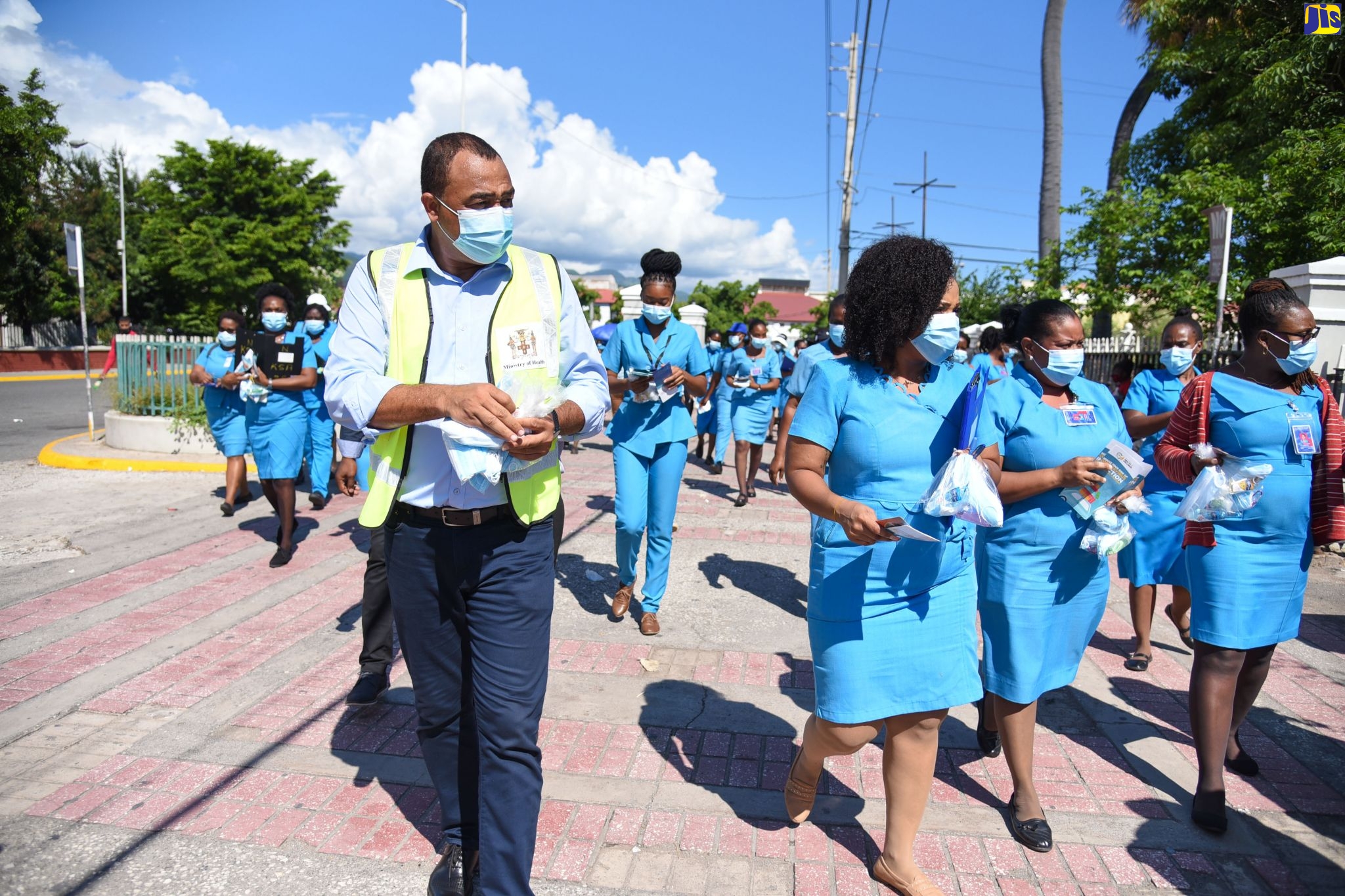 Minister of Health and Wellness, Dr. the Hon. Christopher Tufton (left), and a team of Community Health Aides engage in a public education exercise on COVID-19 at Parade in downtown Kingston, on Monday (September 28). The activity is part of the Ministry’s ongoing public education campaign to engage with citizens across the island, and to distribute masks, sanitisers and educational materials on safety measures to reduce the risk of contracting and spreading COVID-19.