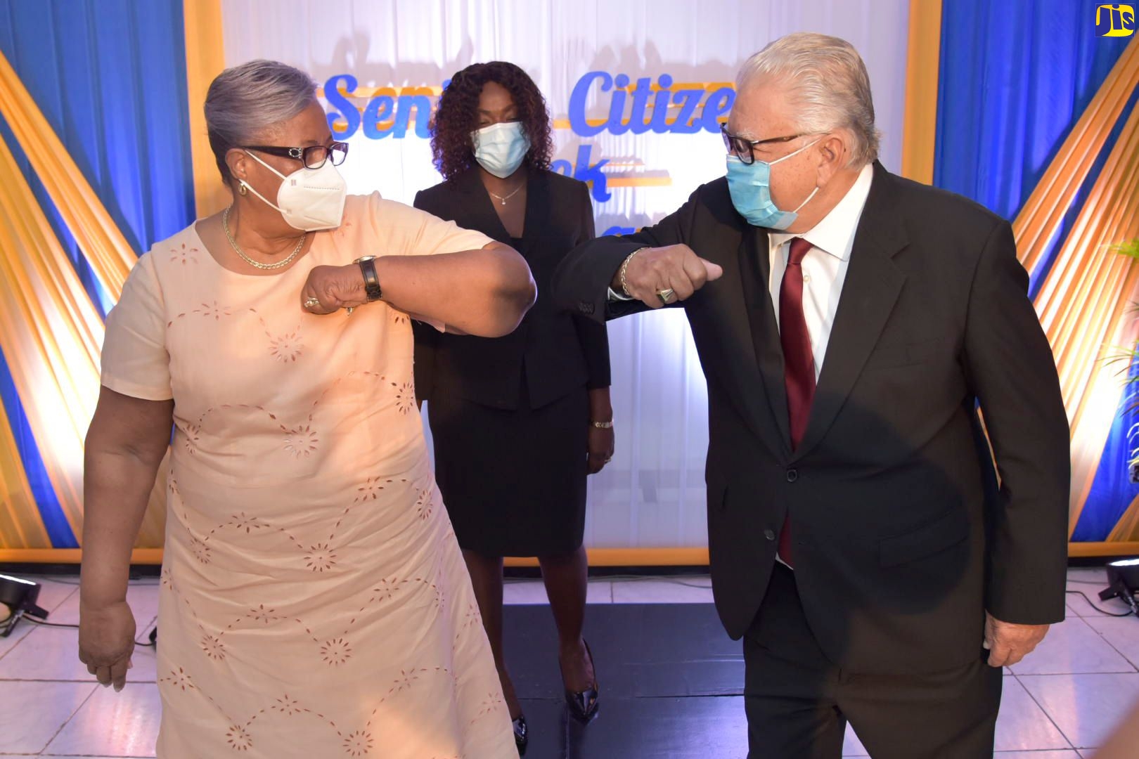 Minister of Labour and Social Security, Hon. Karl Samuda (right), greets Chairman of the National Council for Senior Citizens, Dorothy Findlayson (left), at the media launch of Senior Citizens' Week, at the Ministry in downtown Kingston on Friday (September 25).  At centre is Principal Social Worker at the Council, Cassandra Morrison.
