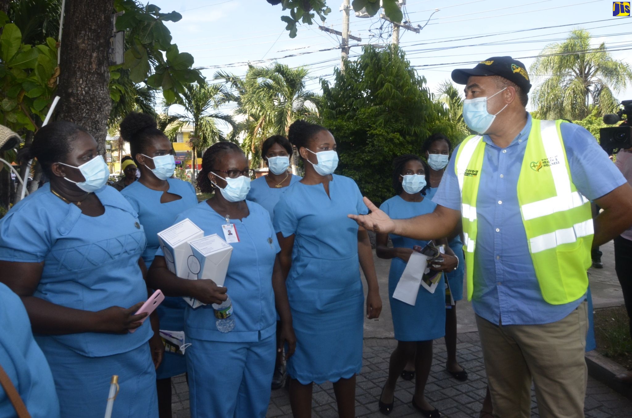 Minister of Health and Wellness, Dr. the Hon. Christopher Tufton (right), addresses community health aides from the St. Ann Public Health Department prior to a coronavirus (COVID -19) sensitisation tour of sections of Ocho Rios in the parish, recently. The tour followed a virtual meeting with members of the St. Ann business community.