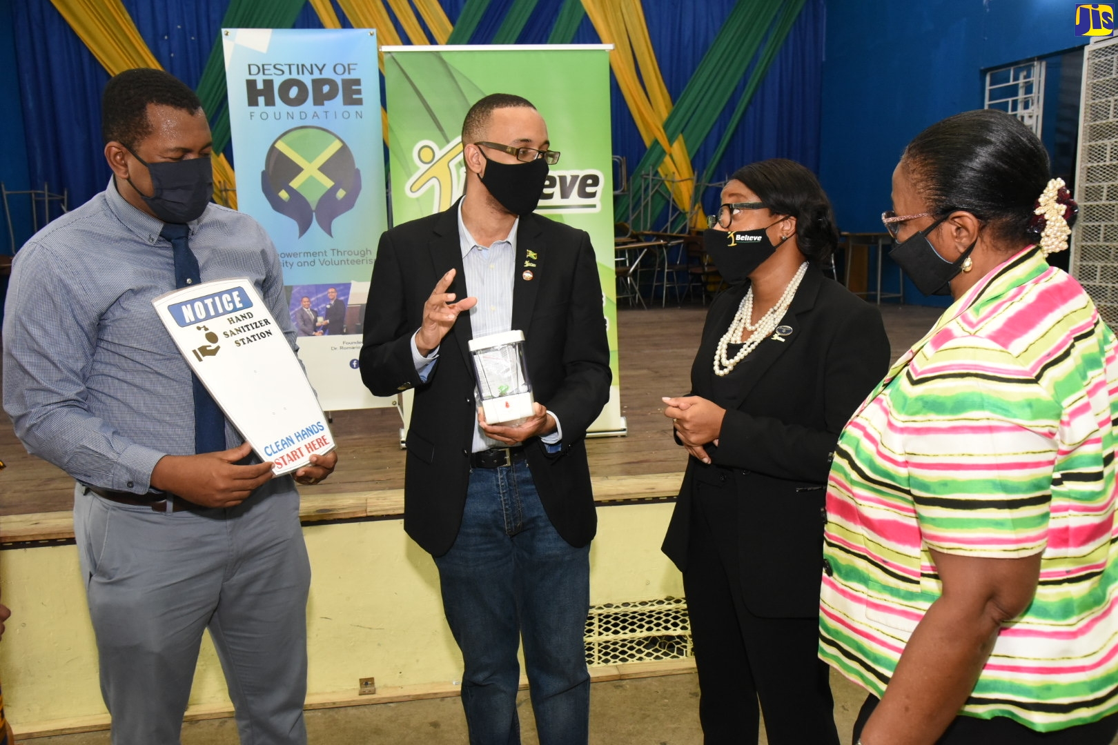 I Believe Initiative (IBI) ambassador, Dr. Romario Simpson (2nd left), conversing with (from left) Acting Principal of Meadowbrook High School, Kevin Facey; National Coordinator, Governor-General’s Programme for Excellence, Sonja Simms; and Custos Rotulorum of St. Andrew, Dr. Patricia Dunwell. Occasion was the launch of the IBI hand hygiene programme and handover of hand sanitiser/soap dispensers at the Meadowbrook High in St. Andrew on Thursday (September 17).