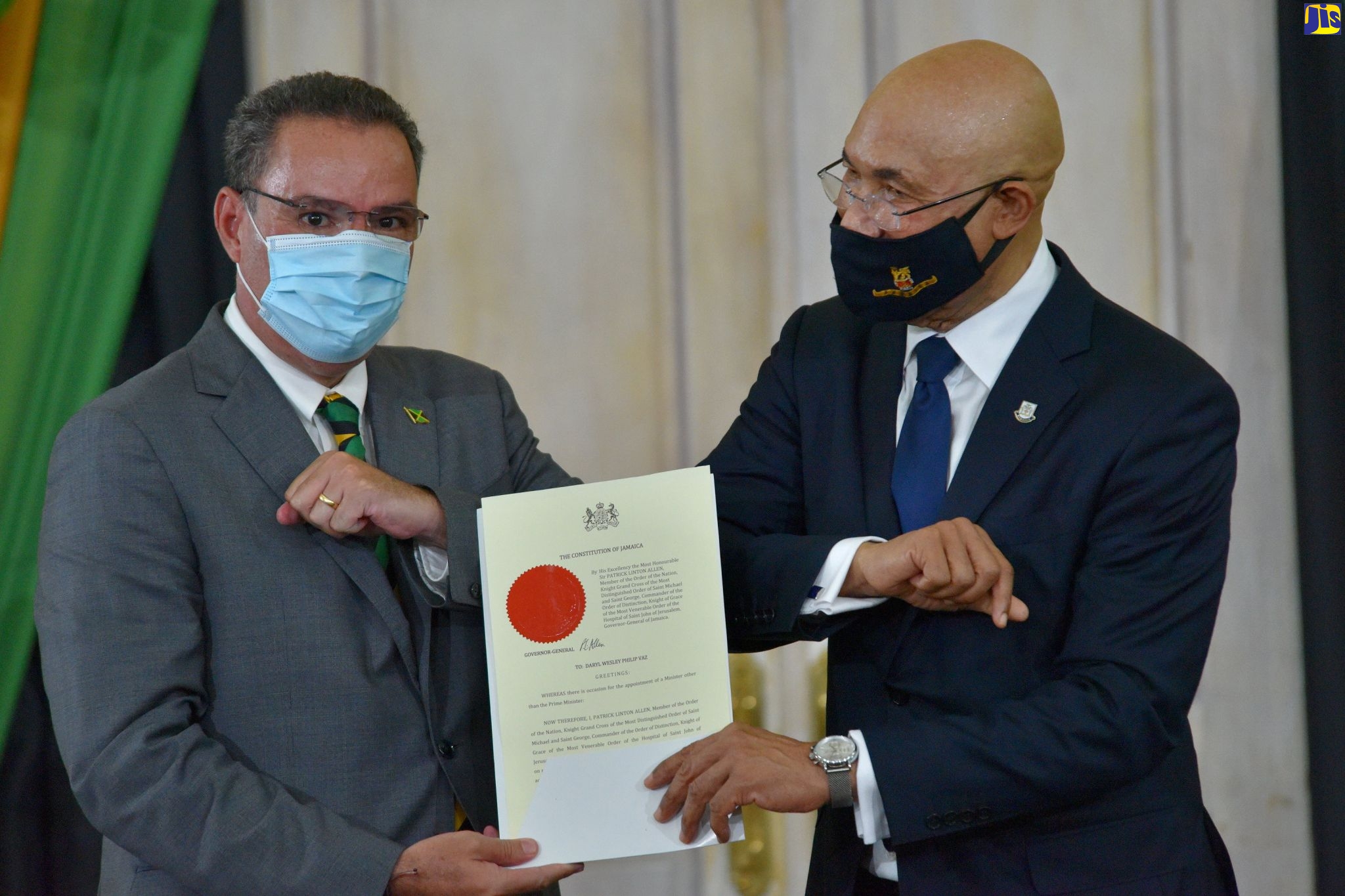 Governor-General, His Excellency the Most Hon. Sir Patrick Allen (right), congratulates Minister of Energy, Science and Technology, Hon. Daryl Vaz (left), after presenting him with the Instrument of Office at the swearing-in ceremony for Cabinet Ministers at King’s House on Sunday (September 13).
