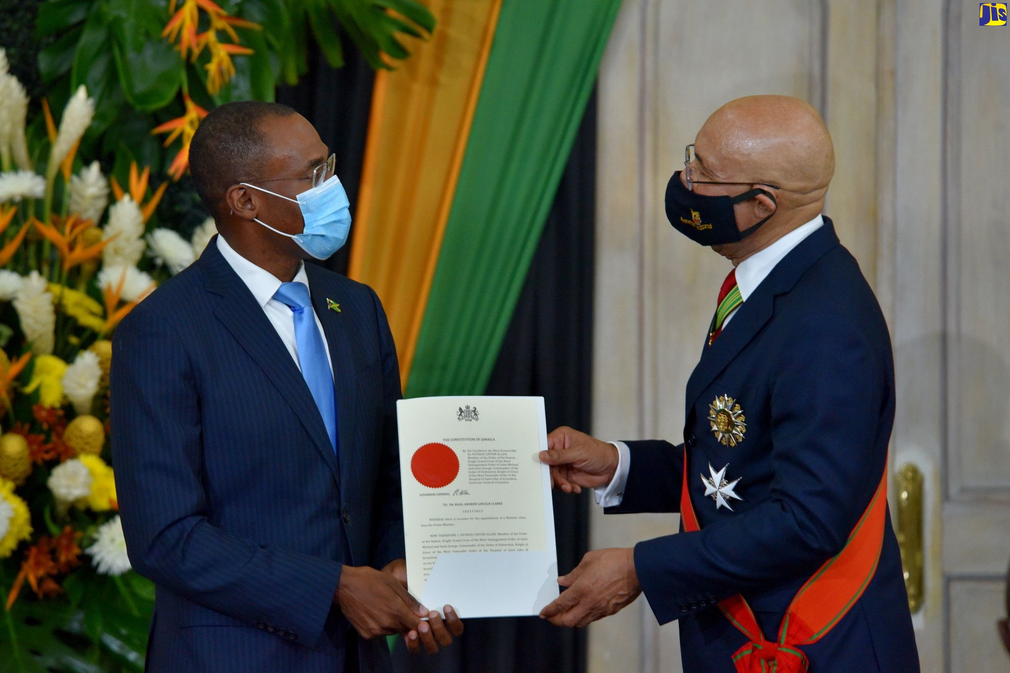 Governor-General, His Excellency the Most Hon. Sir Patrick Allen (right), presents Minister of Finance and the Public Service, Dr. the Hon. Nigel Clarke, with his Instrument of Office, at a swearing-in ceremony at King’s House, on September 7.