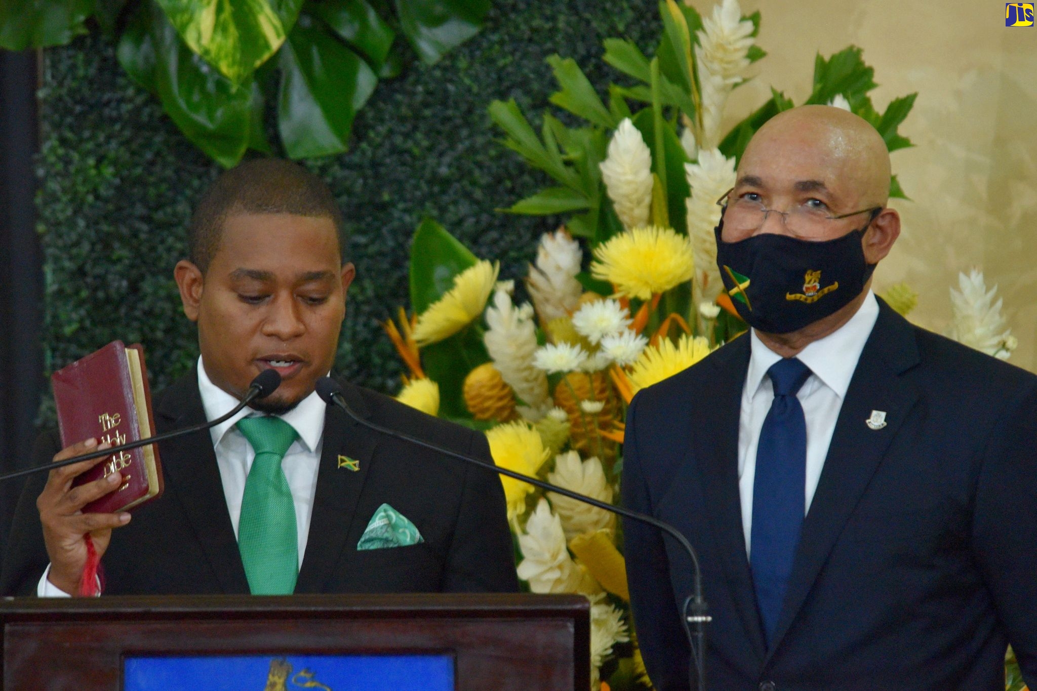 Governor-General, His Excellency the Most Hon. Sir Patrick Allen (right), listens as new Minister of Agriculture and Fisheries, Hon. Floyd Green, takes his Oath of Office at the swearing-in ceremony, held at King’s House, on Sunday (September 13).