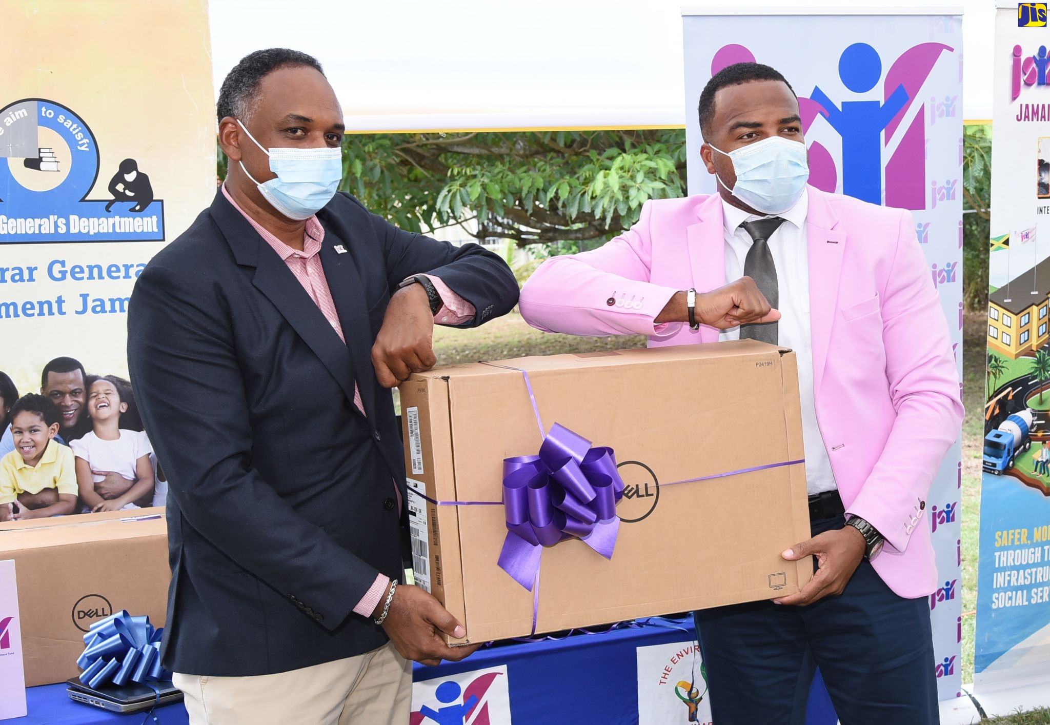 Managing Director of the Jamaica Social Investment Fund (JSIF), Omar Sweeney (left), presents Chief Executive Officer, Registrar General
