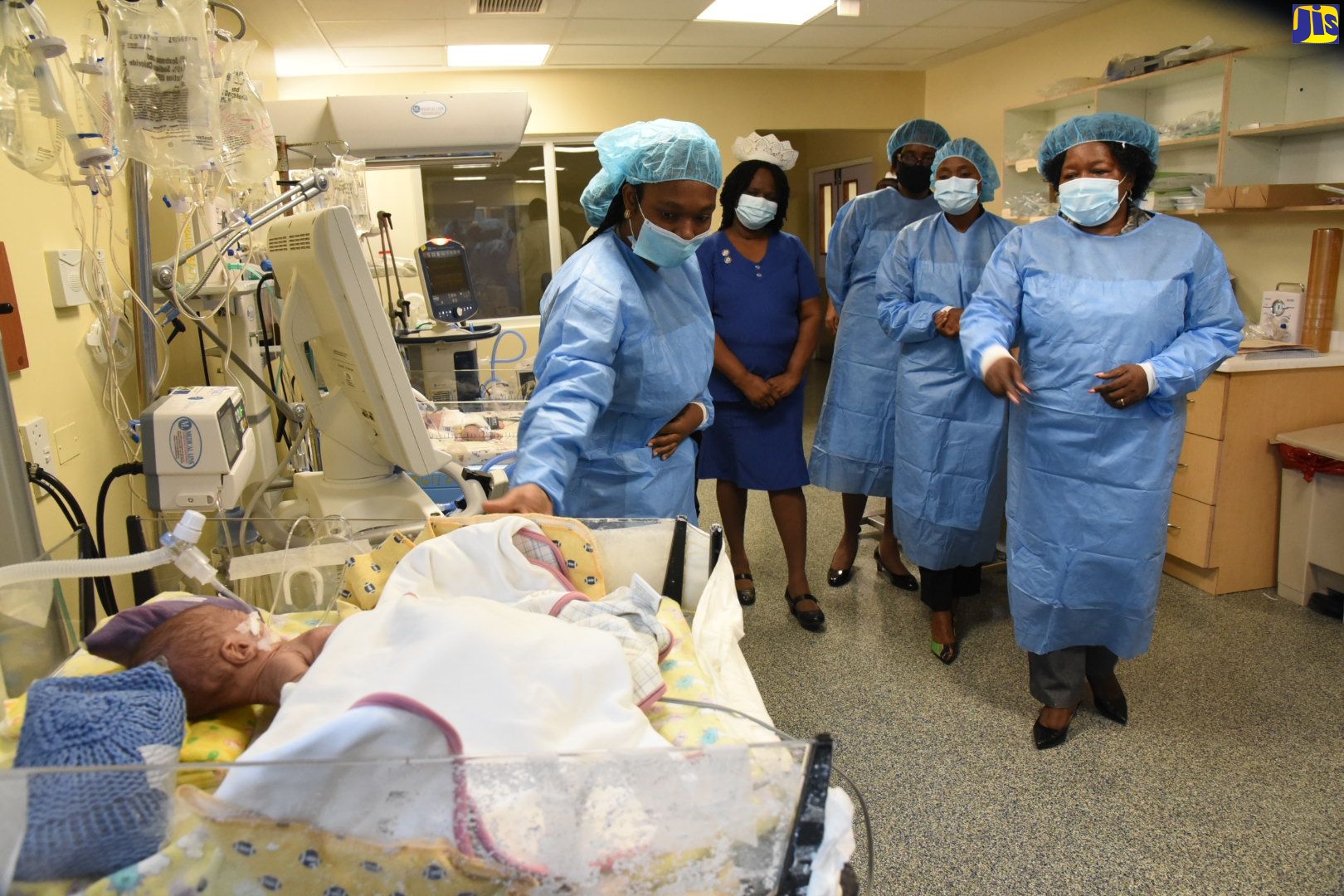 State Minister in the Ministry of Health and Wellness, Hon. Juliet Cuthbert Flynn (second right), observes as Medical Officer in the Victoria Jubilee Hospital (VJH) Neonatal High Dependency Unit Nursery, Dr. Ella Britton-Aiken (second left), adjusts a blanket for a young patient. The State Minister visited the nursery during a tour of the VJH in Kingston on Friday (September 25). Also pictured are Director of Nursing Services, Victoria Jubilee Hospital, Elise Fairweather Blackwood (third left); Director, Health Services Planning and Integration, Ministry of Health and Wellness, Dr. Naydene Williams (fourth left); and Regional Director, South East Regional Health Authority (SERHA), Maureen Golding.